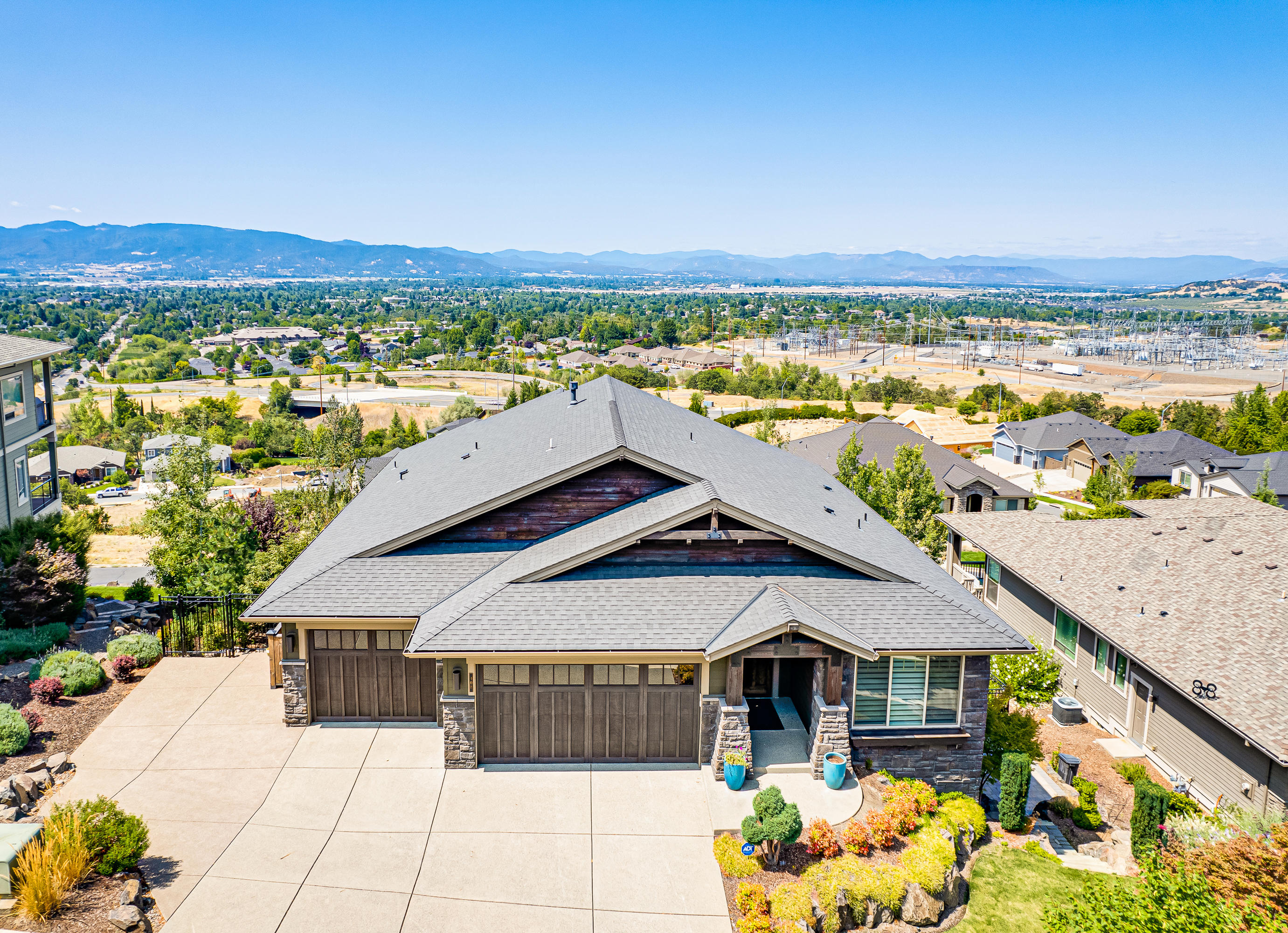 This magnificent home is located in the desirable East Medford hills. If you are looking for a home that has space and spectacular views, this is it! Open floor plan, vaulted ceilings, beautiful rocked archway, large great room w/ gas fireplace on the first floor. Kitchen offers quartz countertops, stainless steel appliances, large island and walk in pantry. Master is on the main floor with a spa like bathroom, walk in shower, soaker tub, walk in closet & Dual vanity. Downstairs you will find 2 bedroom suites, 2nd' great room with amazing tile flooring, 2nd laundry room, Billiard room, wet bar, office and theatre with 7.4 stereo surround and subwoofers under each seat, an office and a storage room. Hunter Douglas window coverings throughout the home. The backyard is a parklike setting including a gorgeous pergola, two large timber teck decks with automated shades. 3 car epoxy floored garage with new age garage cabinets. The list goes on and on, this is a must see!
