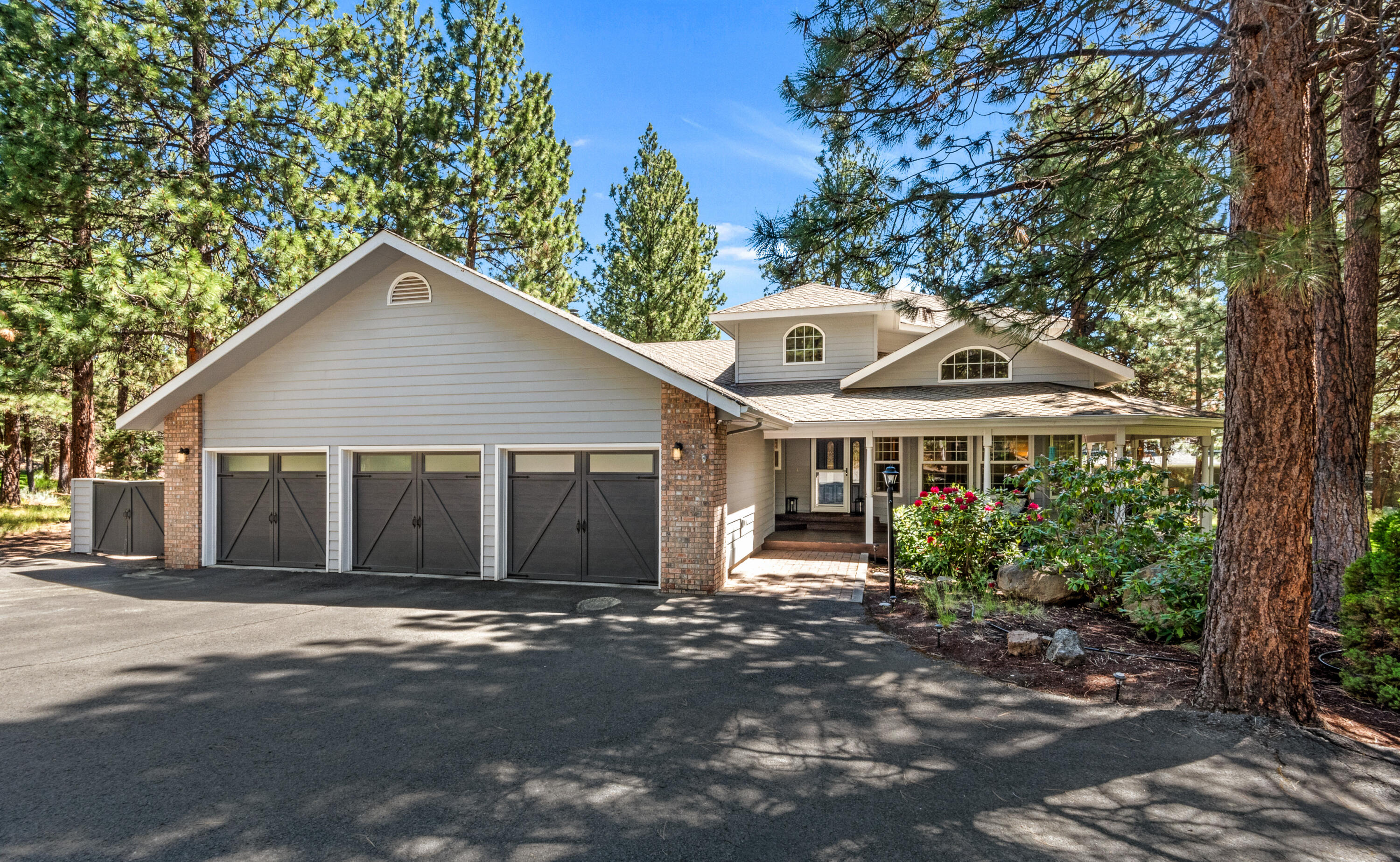 Nestled amidst the serene Ponderosa pines of Awbrey Butte, this charming home offers a tranquil and secluded retreat, surrounded by nature's beauty. Enjoy the perfect blend of privacy and convenience, with easy access to downtown Bend, the Old Mill District, and nearby trails leading to Mt. Bachelor. Step inside to find a warm hardwood foyer leading into the adjacent living and dining rooms. The updated kitchen seamlessly flows into the inviting great room, overlooking the rear deck and lush yard. Retreat to the main-level resident suite, featuring an updated bathroom for ultimate relaxation. Downstairs, discover an additional en-suite guest room, while upstairs boasts three more bedrooms and another updated bathroom, providing ample space. With a large three-car garage for all your Central Oregon adventure gear and Summit Park's amenities nearby, including a sport court and tennis courts, this home truly offers the perfect balance of comfort, convenience, and outdoor living.
