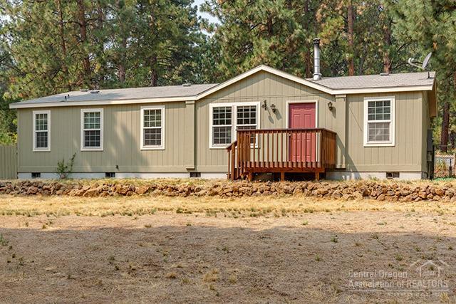 Immaculate manufactured home on a full foundation! This home is move in ready- featuring vaulted ceilings, a certified wood stove, updated guest bath and flooring, & a 1200 SF shop w/10' walls, windows, 100 amp 220 service, and a 16' double door. Sited on over half an acre fully fenced, this property is an outdoor oasis- with front and backyard cedar decks, raised garden beds, canal access, and a large front yard with mature landscaping. This property will qualify for FHA/VA.