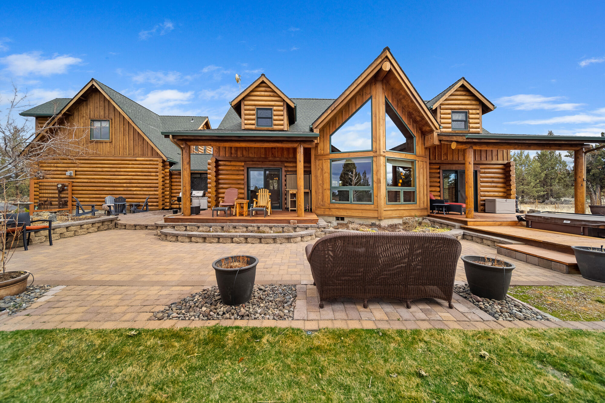 Gorgeous, meticulously maintained, custom log home on 11 acres in Juniper Ridge, one of the premier neighborhoods in Central Oregon. Bright and airy home with primary suite on the main floor, flex space throughout, great room and gorgeous kitchen! Solid counters, social island bar seating, stainless steel appliances, gas stove and imported stone floors make this kitchen a wonderful entertaining space.  This home also has a very large detached shop as well. Window filled walls with peekaboo views of the Cascades bring tons of light into the living  area. Primary suite offers spa inspired bath with lounge tub, separate shower, dual vanities and expansive walk-in closet.  Guests are sure to enjoy the spacious living area, luxe bath and two large bedrooms upstairs. 3 car garage and ample storage for activity gear. Located just minutes from Bend with quick access to golf, dining, hiking, schools and surrounding areas.