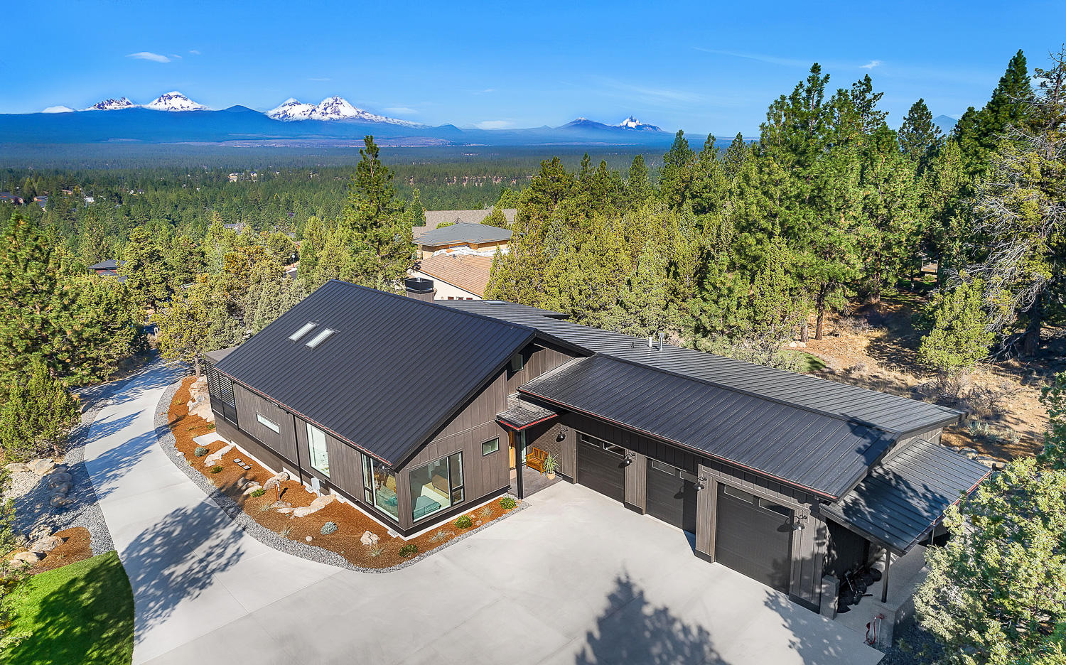 Welcome home to your personal sanctuary in this Modern Farmhouse! Thoughtful design melds with an incredible setting in this award winning, single level home on the western edge of Awbrey Butte. Wildly sophisticated, yet laid back and grounded; this house is that rare gem. The expansive great room forms the heart of this home combining 20' vaulted ceilings and expansive windows to soak up mountain views from every angle.  The great room and primary suite offer seamless connection to outdoor living on the western deck. Luxury abounds in the primary suite which offers floor to ceiling windows, heated floors, double vanity & oversize dual head shower with its own mountain view window. An additional office/flex room, two more beds, two full baths with heated floors complete the living space. 3 car garage w/ Adventure van 10' door provide lots of fun and room for gear. This combination of location, top tier mountain views and design is a rare opportunity you will not want to miss!