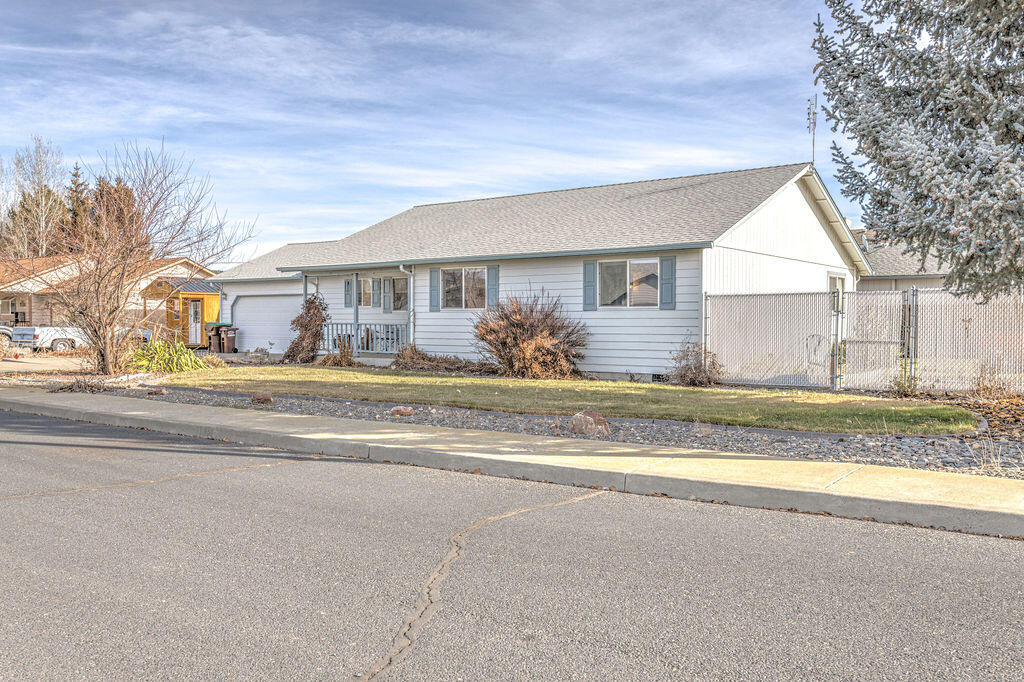 Tidy corner lot home, with room to park an RV or boat! This three bedroom/two bath single level home is open and bright with vaulted ceilings in the great room.  It has a large utility room with a sink, wide hallways and a comfortable on suite.  The yard has raised flower beds and in ground sprinklers.  There's a storage shed and the lot is cycloned fenced with a large gate for containing kids and/or pets.  Good proximity to the schools.