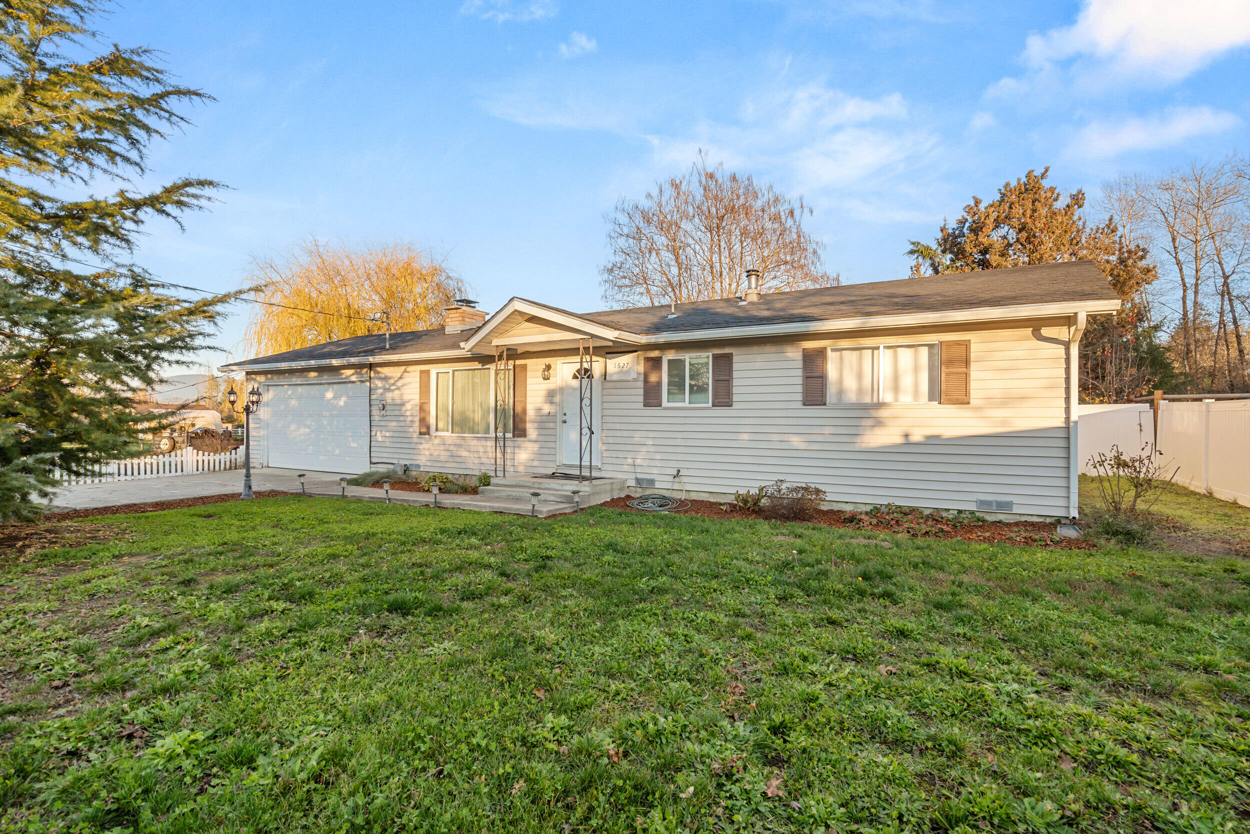 Well-kept 3 bedroom, 2 bath home on a .65-acre lot. Functional floor plan with two bedrooms and a full bath on one side of the home, plus a third bedroom/office off the main hall. Spacious living room with a brick fireplace and large picture window. Remodeled kitchen features granite counters, updated cabinetry, double ovens, and a clean flow into the dining area with slider to the backyard. Property includes mature landscaping, open lawn space, and a pond feature for added appeal. Plenty of room for gardening, RV parking, or future outdoor projects. One-level living with a comfortable layout and usable acreage.