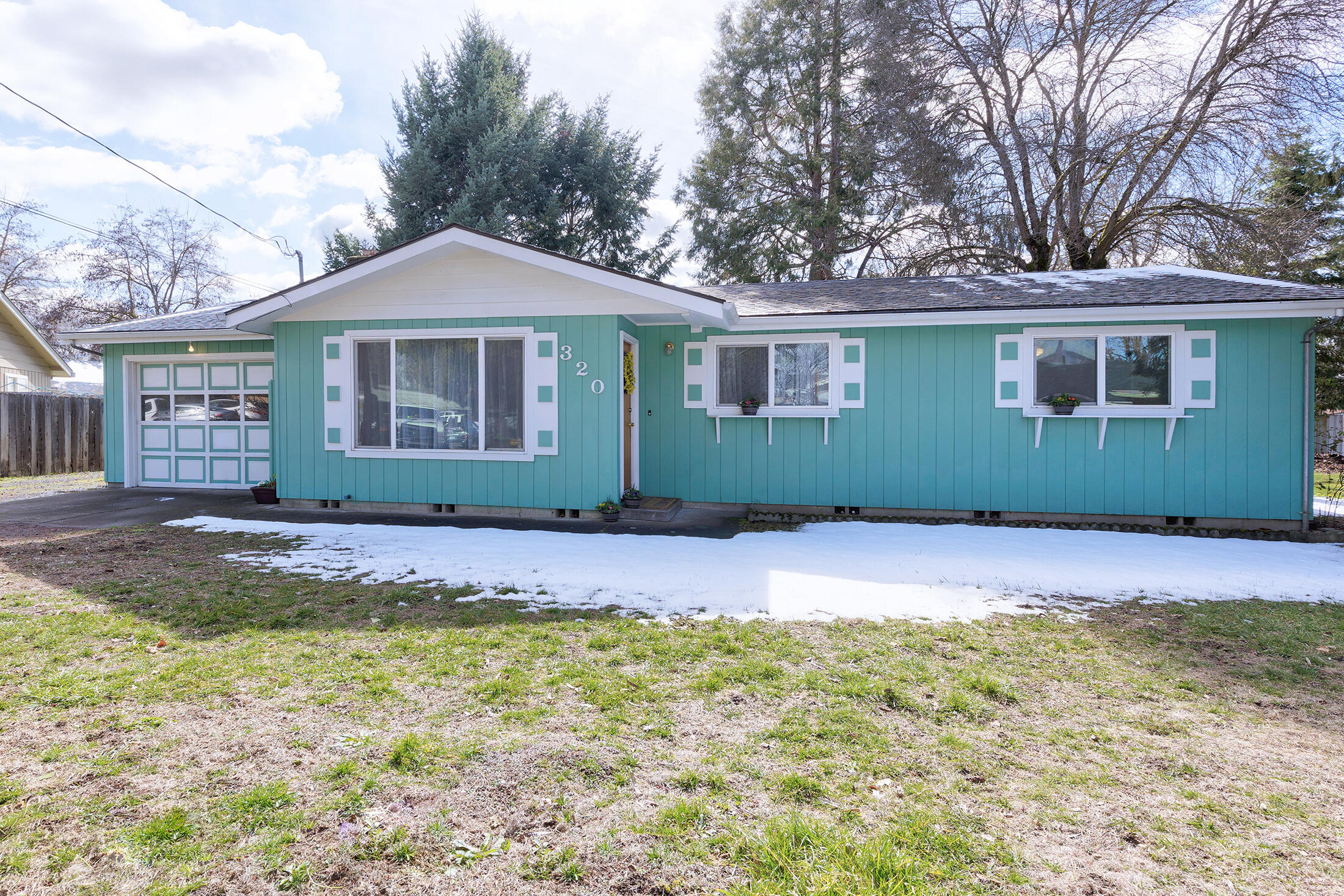 Charming and cozy home, tucked back into a quiet, rural Eagle Point cul-de-sac.
Home has been well loved and well cared for. It features a large outdoor cemented covered patio great for entertaining. As well as a sizeable, landscaped yard with an established garden area. The back yard also includes 2 storage sheds and a 3rd larger shed which has been used as a workshop with lights and power. The interior of the home boasts an original red brick fireplace with glass, updated with fresh paint, new carpet, and hardwood floors that lay under the new carpet.  A new heat pump was installed in 2019, a newer roof, and newer energy efficient vinyl windows throughout the home. The driveway allows for multiple vehicles as well as RV/Travel Trailer parking along the side of the attached garage and offers rear gate access to the property. The one car garage is finished and has additional
shelving and storage. The home sits situated in a neighborhood setting, near schools and local businesses.