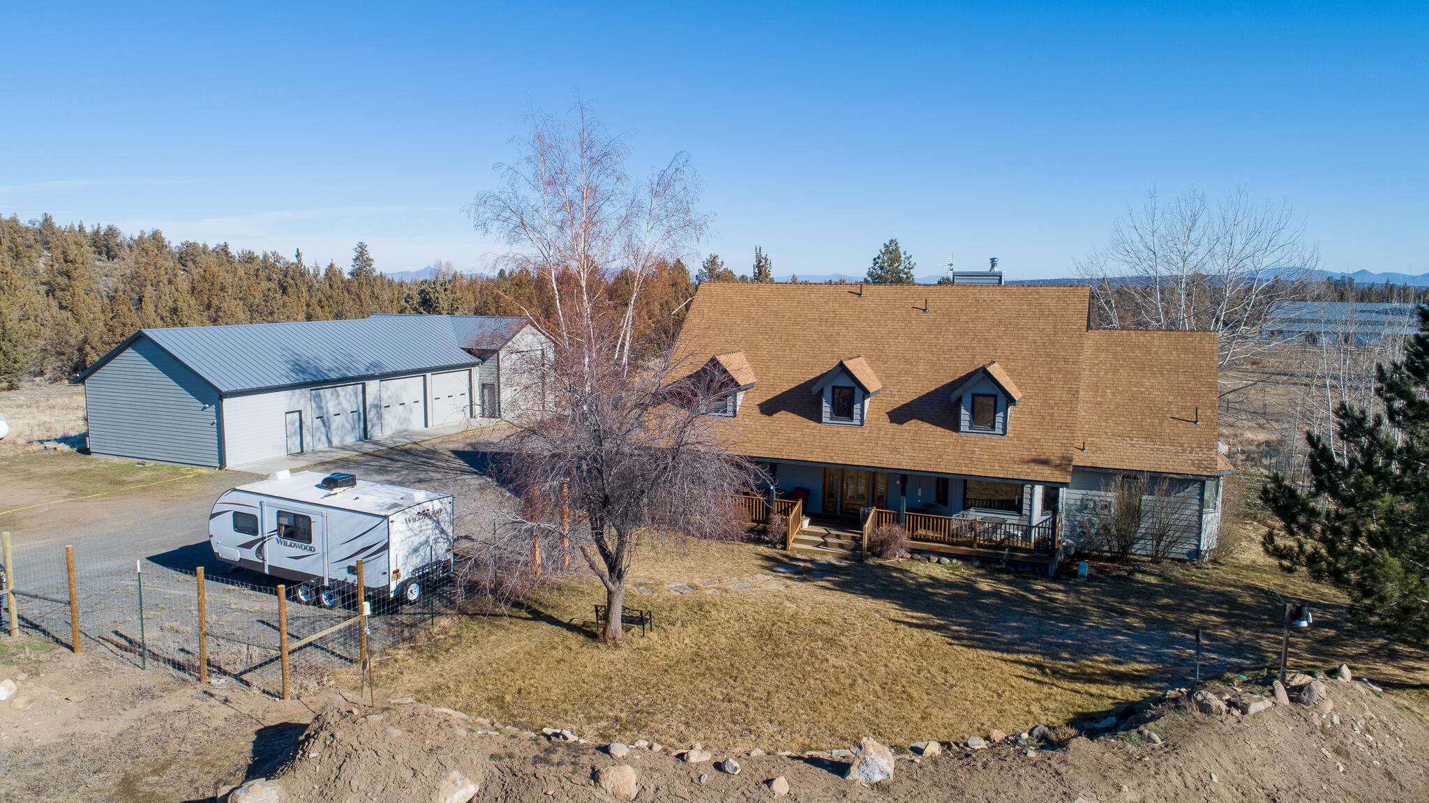 Beautiful 4 bedroom, 2.5 bath home with 2957 sf of living space on this 5.85 acre home with Cascade Mountain views. This home features a large primary bedroom on the main floor that has amazing views of the Cascades. Property features include home office, hobby room, and additional bedrooms upstairs with a Jack & Jill bathroom and bonus room. A heated workshop, indoor RV parking with/30AMP service with additional 30/50AMP RV service outside the shop. Commercial grade 30x72 greenhouse with 65000BTU propane heater, fan & Louvers temperature control system. This land includes 2.5 acres of irrigated rights, fenced and cross fenced.