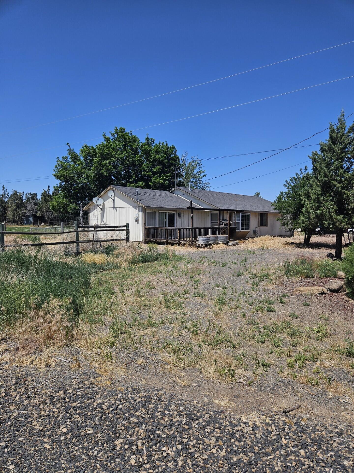 Located just out of town, this 5-acre fenced horse property offers a rare opportunity for country living with convenience. The single level home is ready for your personal touch and updating to bring out its full potential. Ideal for equestrian enthusiasts, the property features a barn and multiple outbuildings, providing ample space for animals, equipment, and storage. With open land, room to roam and a quiet setting, this property is a great canvas to create your rural dream close to town amenities.