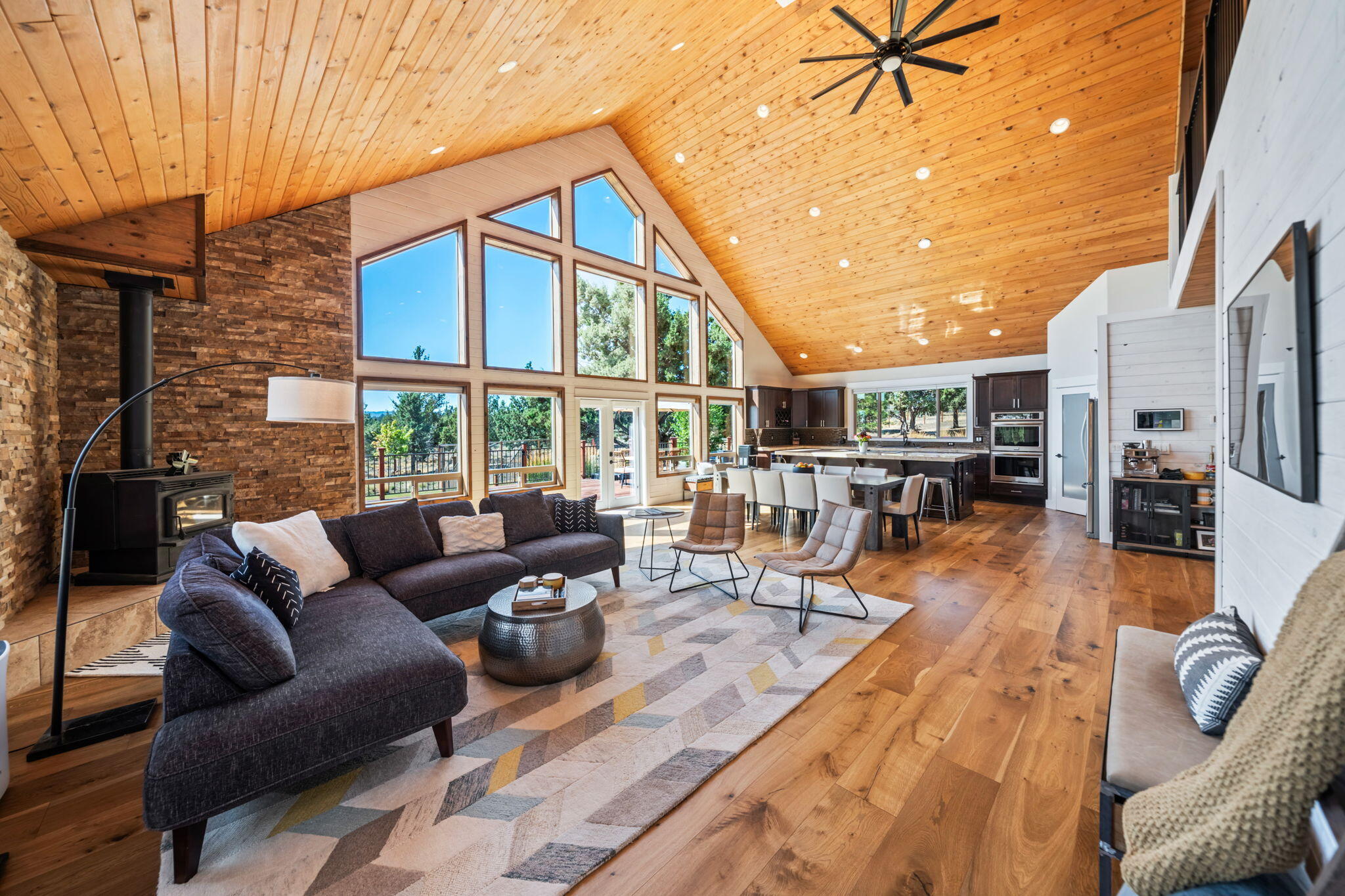 More than a home—this is 9.35 acres of modern living and endless possibilities. The 4-bedroom, 3-bath main house offers 3,204 square feet of open-concept design, featuring wide plank hardwood floors, bright modern bathrooms, and freshly updated interiors. Large Kitchen has ample natural light, room for entertaining, stainless appliances, solid surface counters. Primary bedroom on the main level with a knock out walk in closet. Outside, it's a private playground: lush landscaping, basketball court, fire pit, raised garden beds, trampoline, and room to roam—all with privacy. The extras: a 432-square-foot outbuilding ready for your vision, an oversized 3-car garage w/ an exercise room, office with half bath, and an 800+ square foot bonus theater space above. Property blends style, function, and pure fun. Garage features additional attic storage, 50 Amp service on the outside panel. RV parking ready!
