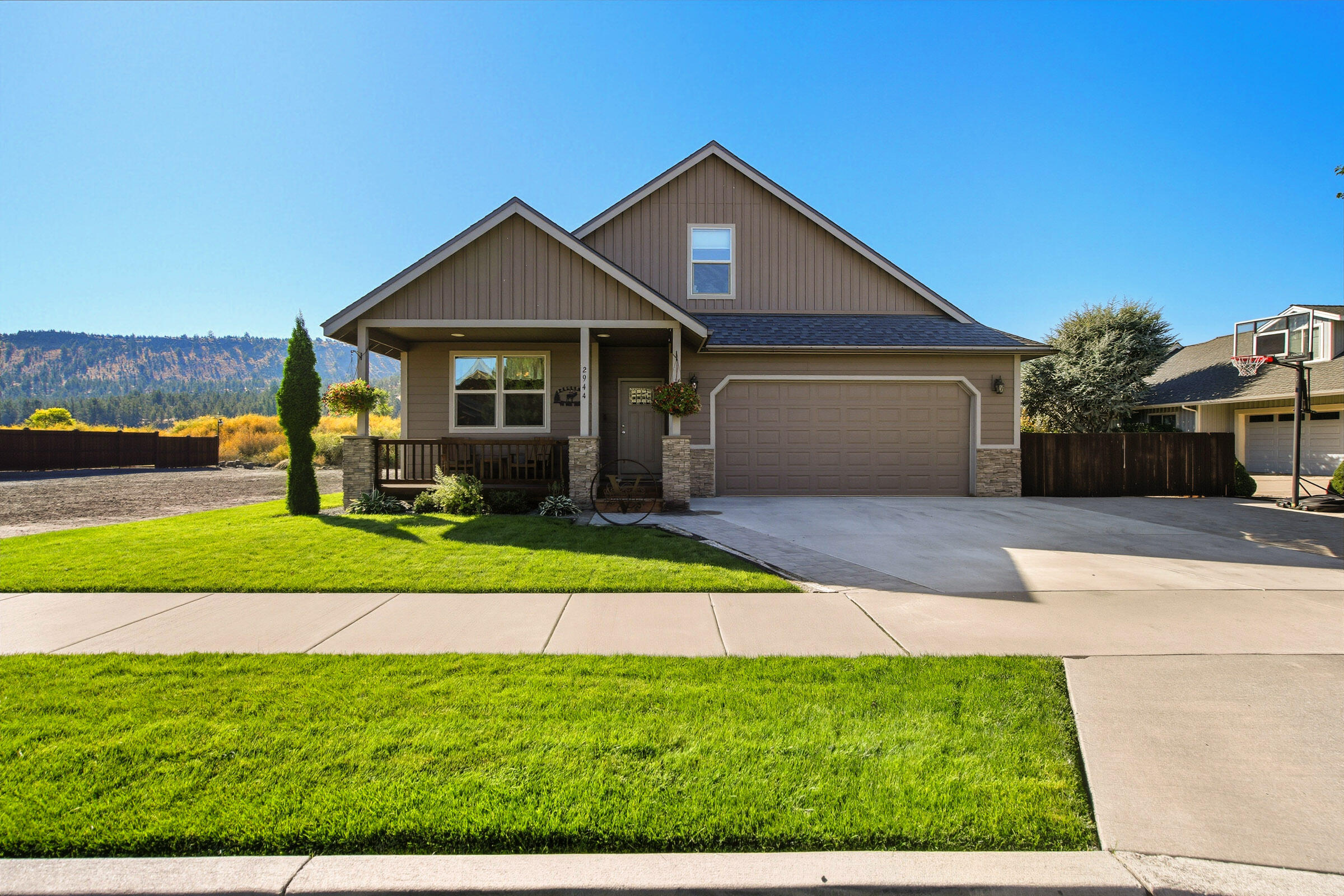 Custom-Built Modern Comfort with Creekside Living. Built in 2021, this 3-bed, 3-bath, 2,511 sq. ft. custom home sits on a .36-acre lot with a tranquil creek. Enjoy single-level living with a 329 sq. ft. bonus room upstairs. The primary suite offers two walk-in closets, dual vanity, soaking tub, and shower. A second suite with full bath is ideal for guests or multigenerational living, while the third bedroom fits a king bed plus office space, with a full bath nearby. The kitchen features all-gas appliances, pantry, and ample prep space, with durable commercial-grade LVT flooring throughout. Outdoor living includes a covered paver patio with gas fireplace, TV, and hot tub overlooking the creek, while drip irrigation keeps landscaping low-maintenance. The oversized 24x26 garage with 18-ft door offers plenty of storage and workspace. This home perfectly blends comfort, craftsmanship, and nature—schedule your private showing today!