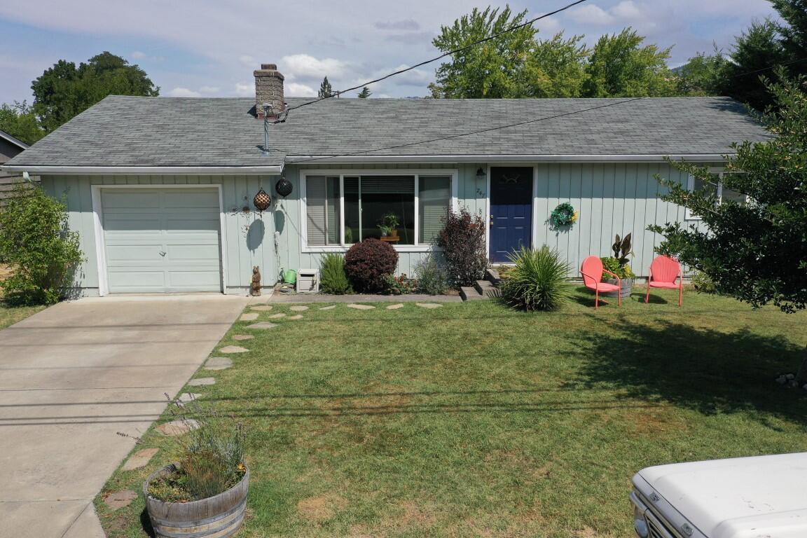 Super Ashland Single-Level Home on a Large Sunny Lot. Plenty of room to grow in this two bedroom, one bath, 1,034 square foot 1960's ranch-style on an easy access street in Quiet Village. Nice amenities include loads of hardwood flooring, spacious living with fireplace, galley-style kitchen with plenty of cabinetry, big pantry/laundry, good sized bedrooms, roomy bath, upgraded vinyl windows, gas heat and oversized single garage. The 21/100 acre lot with big patio will easily accommodate adding an owner's suite with private bath, or there's easy access to the huge, well-fenced backyard to build an accessory dwelling (check with the city). Tidy and well-maintained, this one's got great potential for owner-occupied or long-term investment. Don't Miss It!