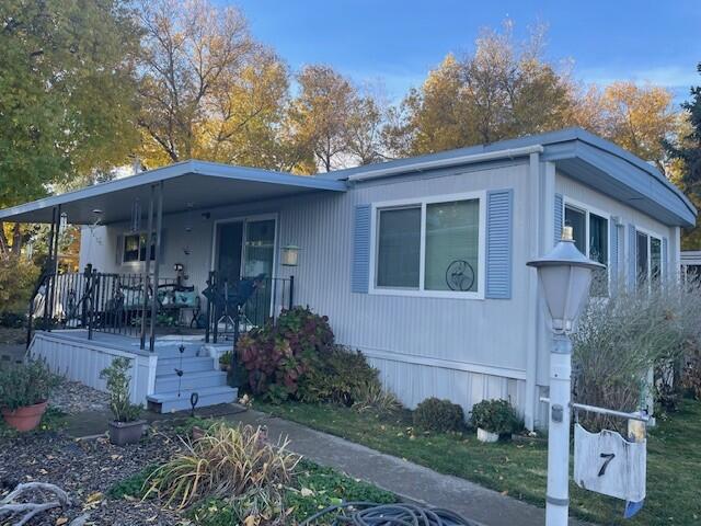 This charming, newly updated 2-bedroom, 1-bath manufactured home, built in 1972, is located in the desirable Blue Spruce Mobile Estates 55+ park. Just minutes from Medford and close to Jacksonville, it offers a peaceful country feel. From the carport, you enter through the laundry area. The kitchen features fresh paint, a new portable dishwasher, new flooring, and plenty of cupboards. The dining room includes a built-in hutch and a large window, while the spacious living room has a cozy sitting area with a large slider leading to the covered deck. The remodeled bathroom boasts a new shower, paint, flooring, and shelving. Recent updates include a new electrical panel, a new roof in 2020, and a new min split heat/air 2023. The low-maintenance lot offers a carport with storage shed, garden shed, partial fencing, and newly graveled extra parking. Move-in ready! Space rent is approximately $575 per month. Open House Sunday 1/11/26 12-3pm.