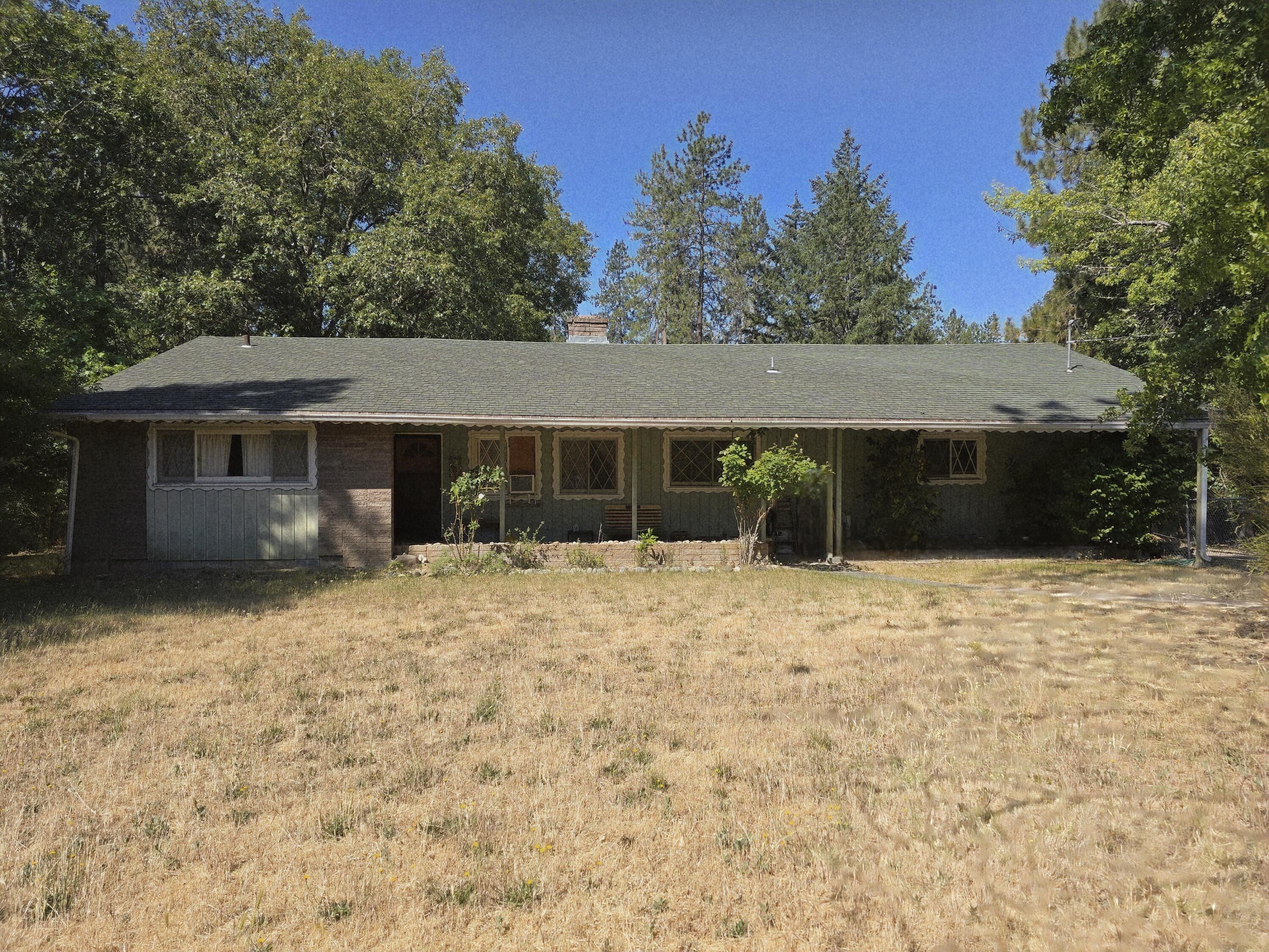 Mid-century single-level home on a large .67 Acre Parcel just minutes from town. This home is at the end of a cul-de-sac on a large, mostly level lot, with a large yard, scattered trees, and plenty of privacy. Featuring a Large country kitchen with plenty of cabinetry, a cozy fireplace, a large living room and gorgeous mid-century brick! The covered front porch is perfect for sipping a beverage and watching the birds and deer. Or, step out back to the large screened-in porch/patio with a built-in barbecue. The two and a half car attached garage, plus additional shop space offers plenty of parking and storage. Home is ready for your personal touches.