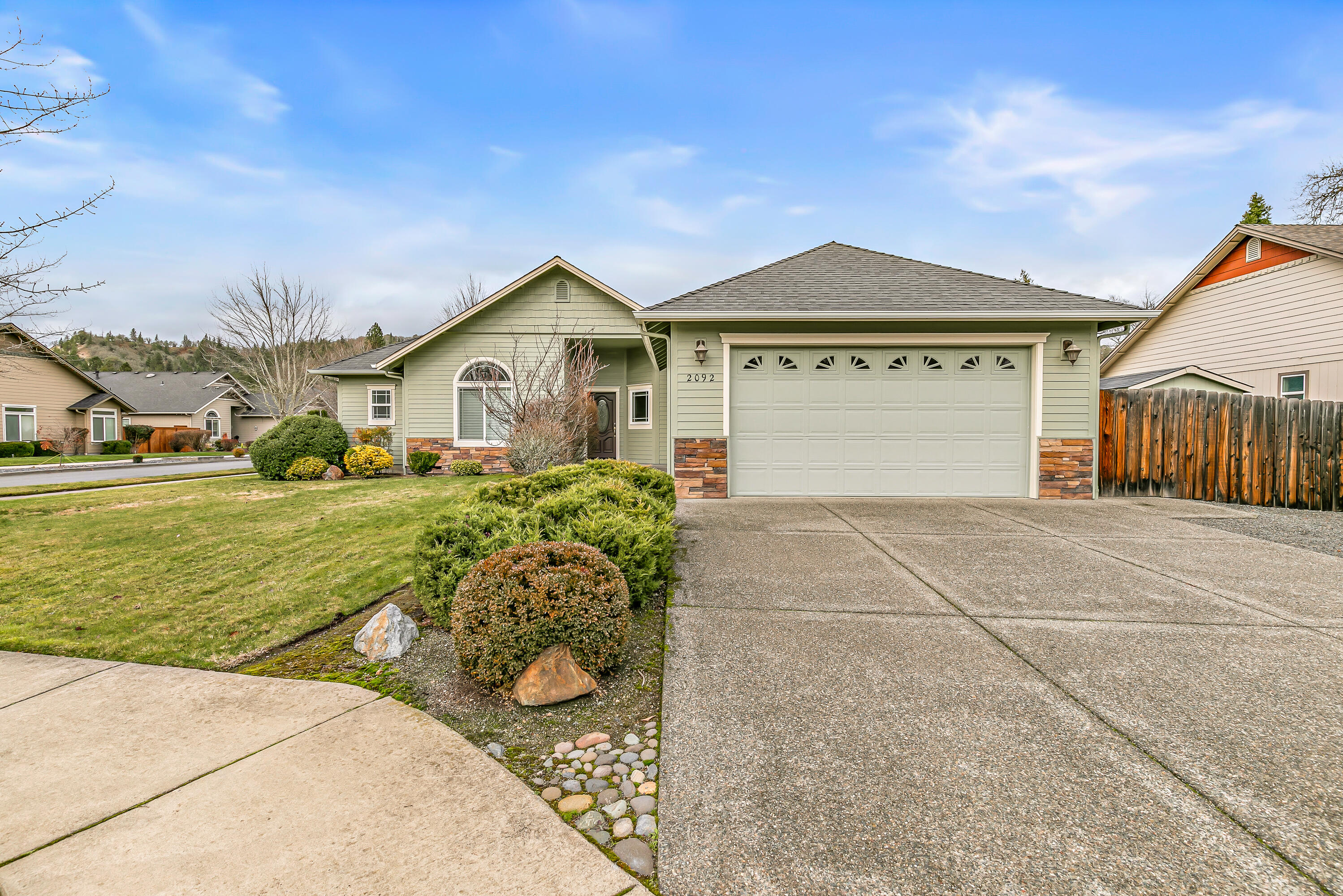 This beautiful 3 bedroom, 2 bath home offers 1,643 sqft of thoughtfully designed living space on a landscaped .19 acre corner lot. Vaulted and recessed ceilings, paired with a stone wrapped gas fireplace, create an open, inviting atmosphere. Real hardwood flooring flows through the main living areas, adding timeless character and durability. The kitchen features granite countertops, stainless steel appliances, a gas range, and a dedicated pantry for added storage. The primary bedroom serves as a private retreat with a walk in closet and private access to the backyard, perfect for quiet mornings or relaxing evenings. With quality finishes throughout and a layout designed for comfort and functionality, this is the perfect home for your next move!