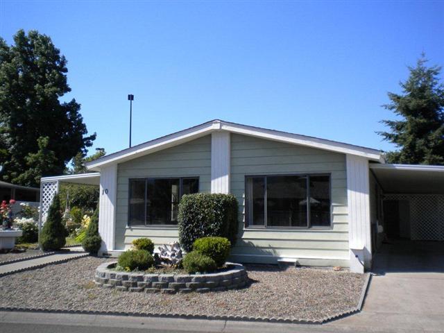 Enjoy the good life in this 55+ Manufactured Home Park with swimming pool, clubhouse and amenities for the active adult! Close to shopping, medical & recreation. Well cared for home with 2 bedrooms, 2 baths, + family room. Kitchen with breakfast bar & tons of cabinets. Vaulted ceilings,lg master suite w/walk-in closet, bath w/ lg shower & garden tub. Washer, Dryer included along with all appliances. Lg Utility Room w/cabinets & desk space. For the handy person there is a Shop/Storage room with work bench. The very nicely landscaped yard and patio are to die for! Room for garden. Enjoy family gatherings and BBQ's on the private patio. Call today to tour this home.