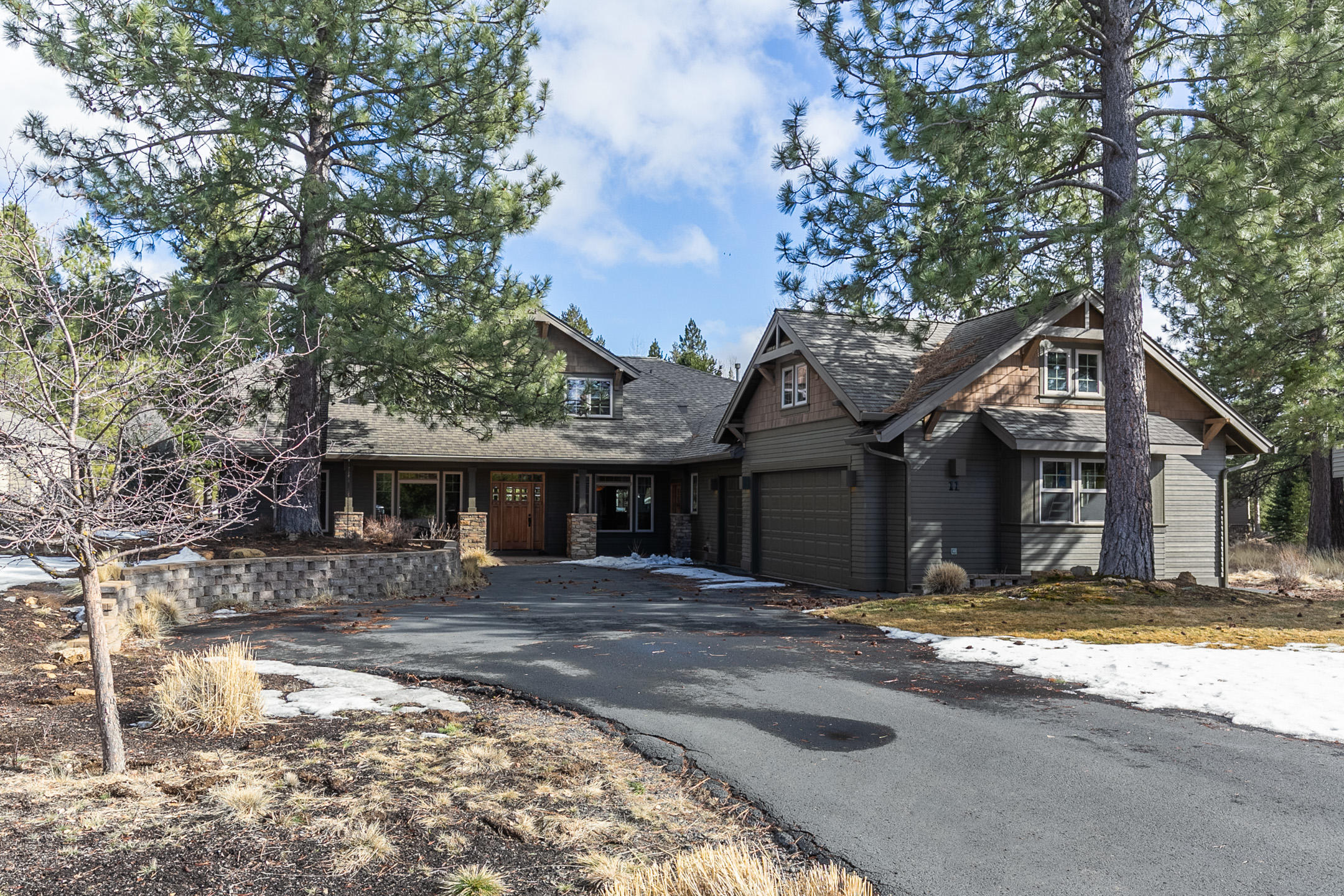 11 Dogleg is a large lodge-style home with a welcoming and warm design. Featuring 4 bedroom suites, and an office, which could easily be a 5th bedroom. Upon entering the home you have the office to your left and the dining room to your right, The dining room opens to the great room and kitchen. The great room has the feel of a lodge with its towering tongue and groove ceiling and floor-to-ceiling rock fireplace. You won't need a thing in the large kitchen with a double oven, breakfast bar, tons of counter space, and stainless appliances. The main primary bedroom is located downstairs with patio access. Three additional bedrooms are upstairs. Outside you will find, covered seating area, a hot tub, and a paver patio that wraps around the back of the house. 660 SF of bonus space above the garage is included in the square footage. Dogleg Lane is located at the north end of Sunriver near the Benham Falls Trail, Sunriver Owners Pool, and the Woodlands Golf course.