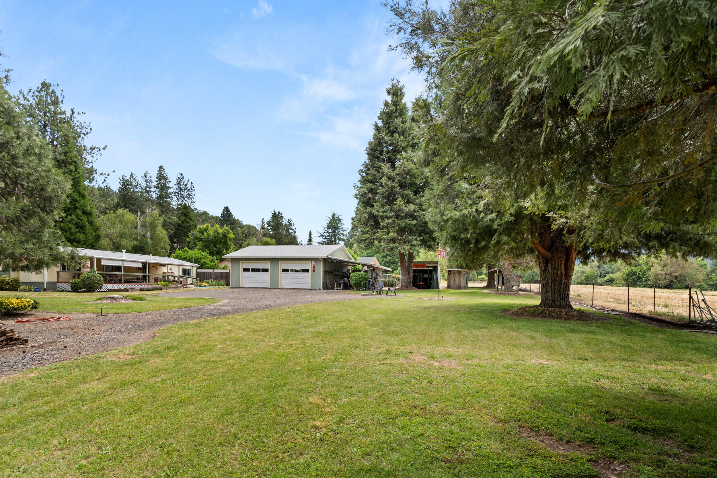 Discover this immaculate 1.15-acre home along serene Griffin Creek Rd, perfectly situated just minutes from the towns of Jacksonville and Medford. Covered front porch along with the even larger back covered patio. This meticulously maintained property has a pasture that could have many uses. including a versatile shop, ideal for hobbies or storage. With irrigation rights, the lush, expansive grounds offer endless possibilities for gardening or outdoor enjoyment. Ample space for RV parking ensures convenience for adventurers. Nestled in a picturesque area with stunning views, this rare gem combines rural tranquility with easy access to urban amenities. Don't miss the chance to own this perfect blend of, functionality, and natural beauty in one of Southern Oregon's most sought-after locations!