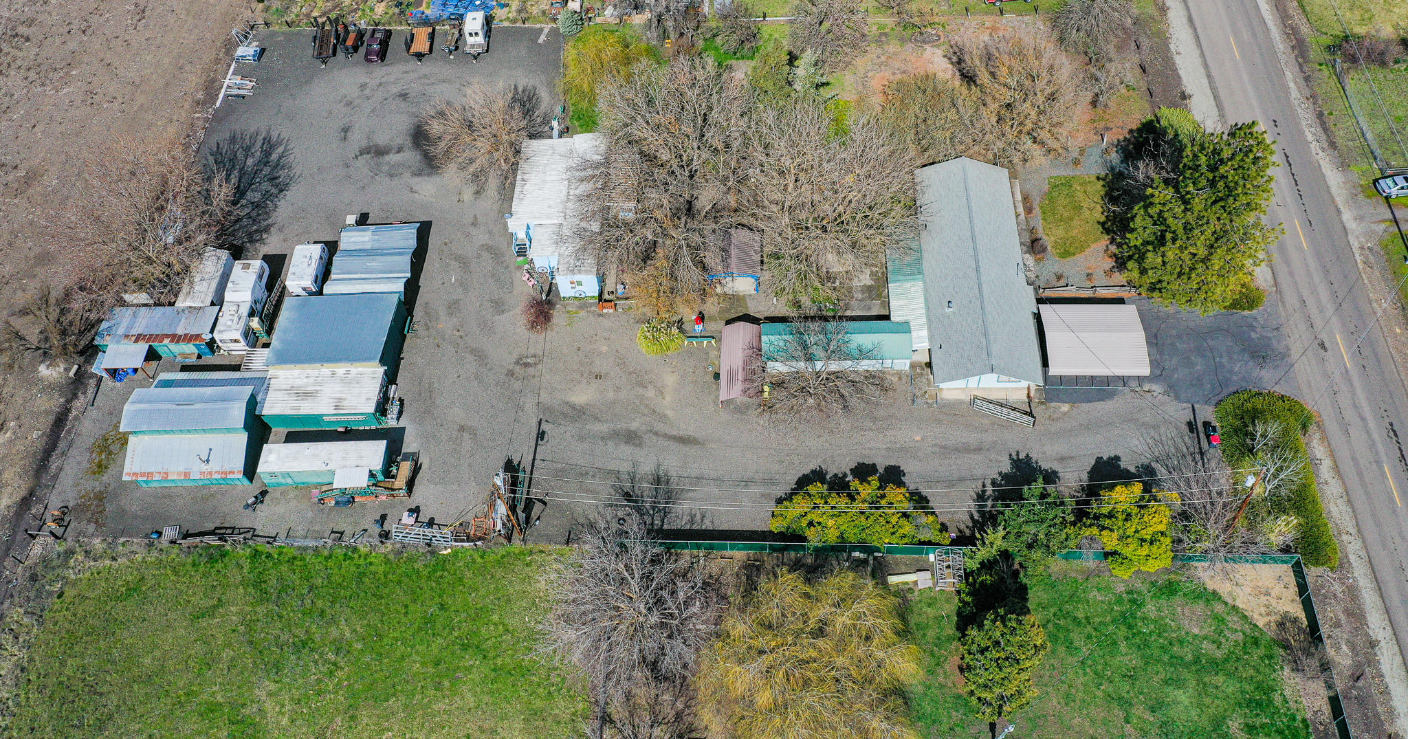 This property has been in the family since 1968! The main house offers 4 bedrooms, 2 full baths, a recently remodeled kitchen & master bath. There's a 1970's ish mobile home that was moved onto the property aprox 30 years ago. It has an attachment added on that makes for a nice living room & oversized room that is presently being used as the main bedroom. Don't be fooled by the exterior looks, as the inside is really nice! The kitchen has been completely remodeled w/ knotty pine wood that came from Lost Creek Lake area. Appliance barn, built in micro, oven range, trash compactor, roll outs & more! All new vinyl windows thru-out. There are many outbuildings, and a barn that was used for wood working, raising sheep, cows & chickens over the years. There's also a 50's mobile home that is now sitting empty. It has newer interior paint & newer carpet inside. No oven/range or fridge, but w/ full bath. Buyer to do own due diligence as far as financing. Check w/ RCU.