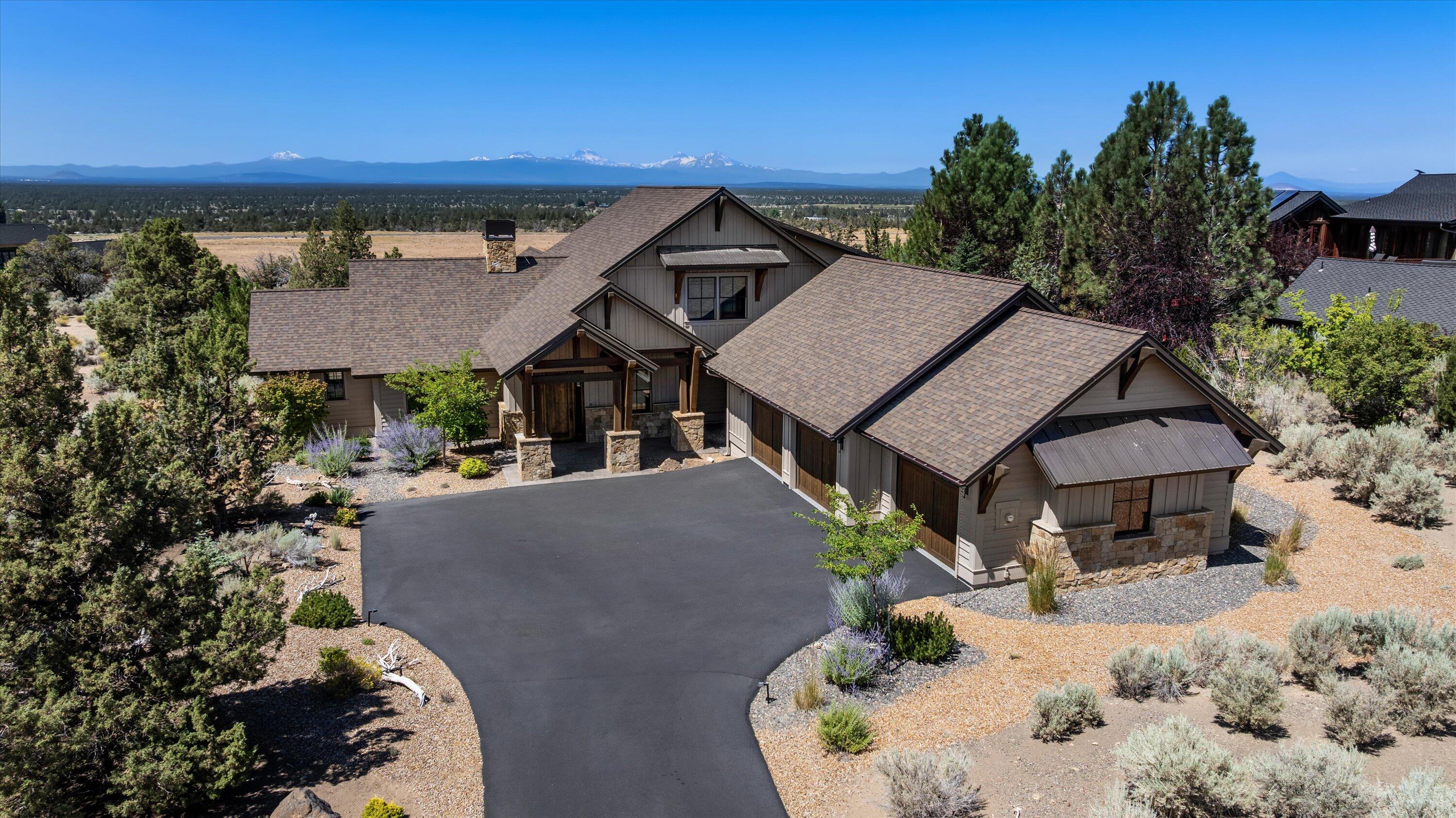 Stellar, Northwest style home with unfettered views of the Cascade Mountains. Inside this exquisite home, you will find an open plan living space with a kitchen perfectly designed for entertaining with its expansive island for gathering, an office, and an open concept great room with a fireplace accompanied by custom built-ins, rising to meet the wood beamed ceiling, that will lead you outdoors to the stone firepit where stunning views of the Cascade Mountains await. Rich and sturdy beams accentuate a spacious covered patio and lends itself to an uncompromised outdoor living experience here at Brasada Ranch. The primary bedroom is on the main floor with a spacious walk-in closet and a spacious primary bathroom. On the second floor, there are two additional bedrooms each with their own ensuite bathrooms. An oversized three car garage offers plenty of storage possibilities and completes this ideal home.