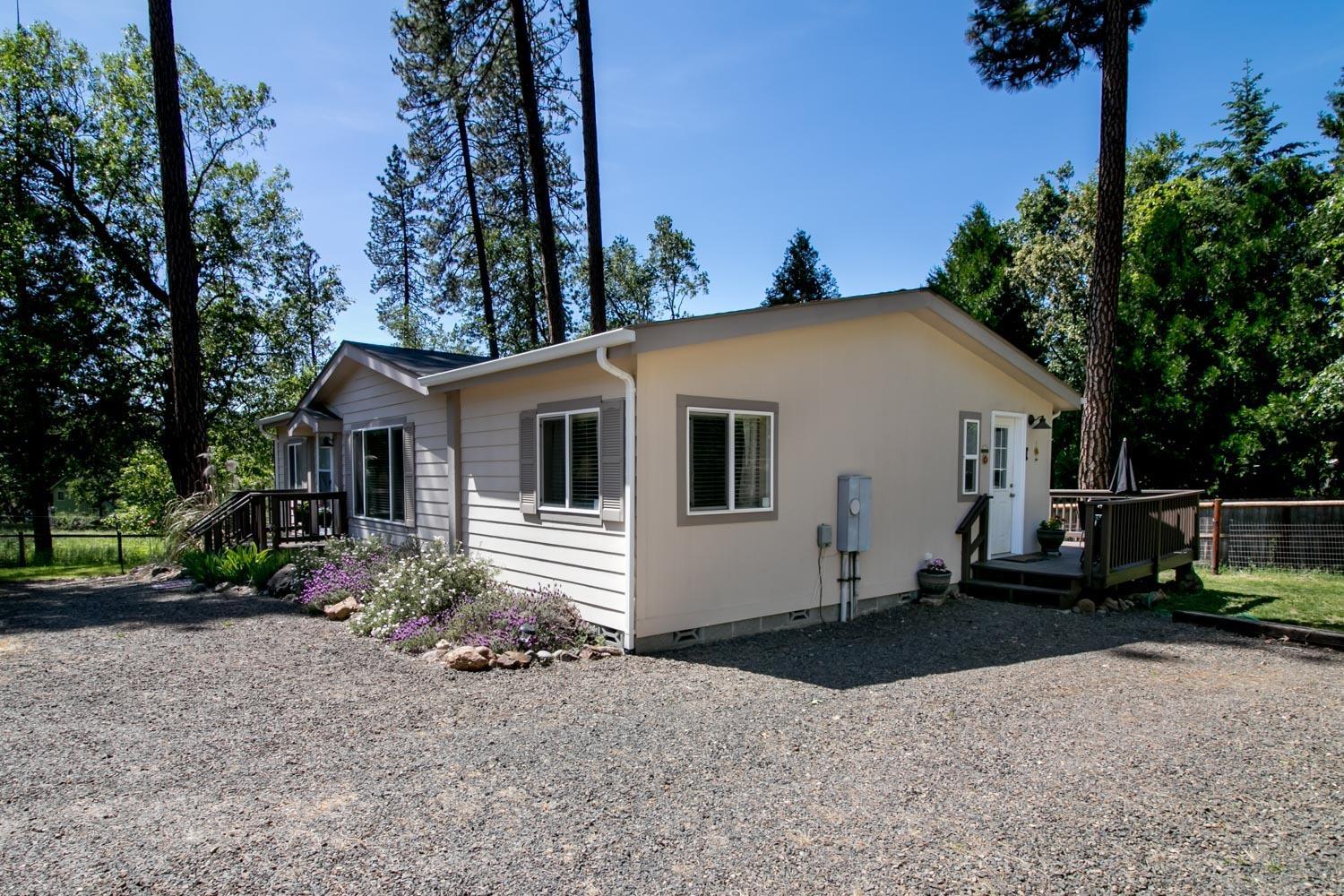 You will love this peaceful, updated, Shady Cove retreat, just a few minutes' walk to the shores of the Rogue River. The Cove Association allows private riverfront access to its residents. Three bedrooms and two bathrooms with open floor plan and vaulted ceilings, new flooring and interior paint throughout. Kitchen island is the perfect preparation space while visiting with guests in the living and dining areas. All appliances are included along with all window treatments! Multiple yards- some fully fenced- ready for gardening, pets, or a place for the kids to play. Relax with a meal on the newly refinished deck and roast marshmallows over the backyard fire under the stars. Abundance of parking space for you and your guests. Store your RV outside or pull it under cover through the large sliding shop door. For your hobbies and storage, utilize the 36'x30' shop with 15'x12' insulated storage room. Is this your next place to call home? One listing agent is related to seller.