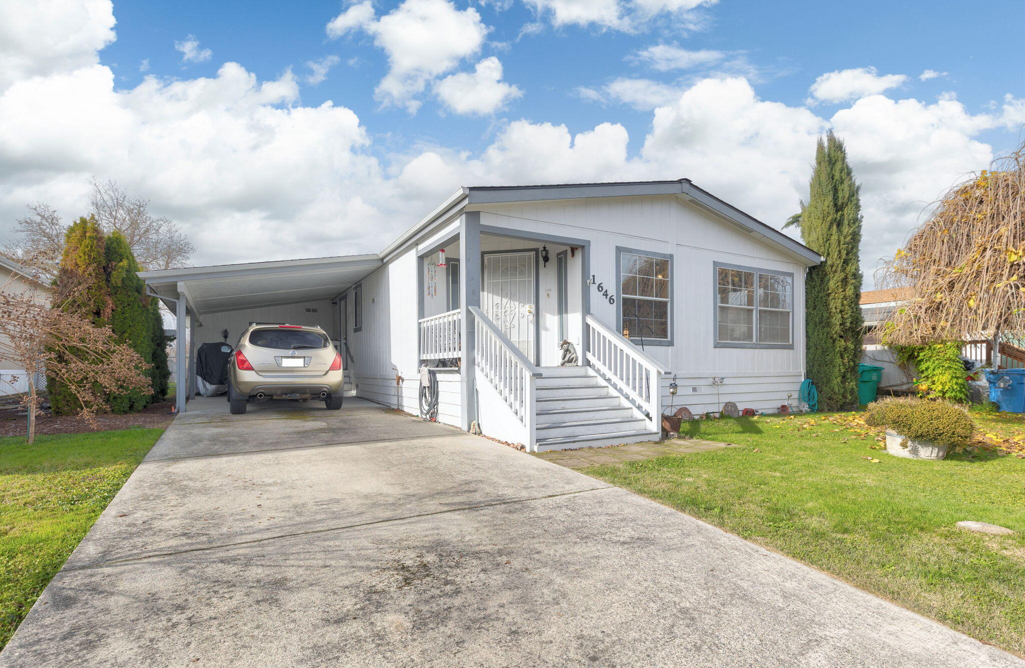 The home is located on a large lot within a manufactured home subdivision. This is NOT a 55+ park. Well-kept double-wide home with a bright and airy kitchen, large living room and master bedroom. The carport has a shed/shop at the back and are attached to the home. Has GPID irrigation available and is paid for by the owners of the land/subdivision. Large fenced backyard. Monthly park space is only $515 plus sewer (amount $48/month). The park pays for the water which is a community well.