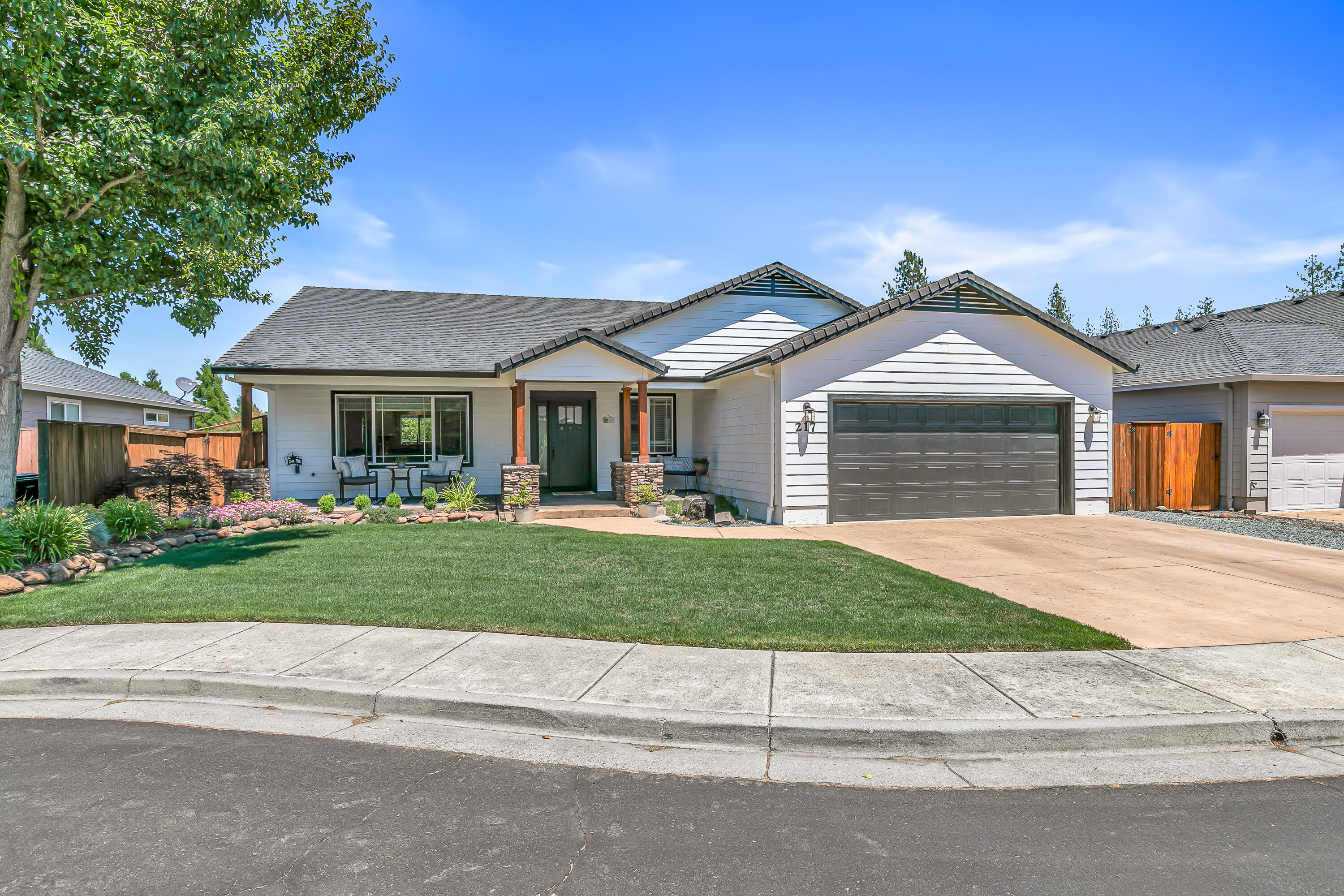 Discover the perfect blend of comfort and style in this beautifully remodeled single-level home, ideally located on a quiet cul-de-sac near a park and just minutes from Eagle Point Golf Course. This move-in ready residence has been thoughtfully updated throughout, featuring an open-concept layout that highlights a spacious kitchen with a large center island, quartz countertops, a stylish tile backsplash, soft-close cabinetry, a farmhouse sink, walk-in pantry, and stainless-steel appliances—including a wine and beverage refrigerator. Custom lighting, vaulted ceilings with a decorative beam, a modern gas fireplace, and high-quality laminate and tile flooring. The primary suite provides a serene retreat with a soaring ceiling, custom double-sink vanity, a beautifully tiled walk-in shower w/dual shower heads, oversized walk-in closet with built-in shelving. Enjoy the beautiful landscaped, fenced yard, water feature, covered patio and front porch. Newer roof, fencing, paint and HVAC.