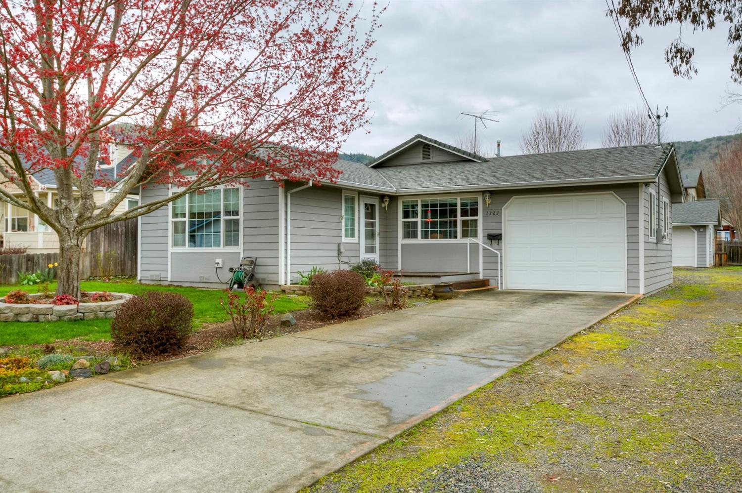 Very well kept home in NW Grants pass just one block South of Washington. Features 3 bedrooms and 2 full baths in the home and a half bath in the detached shop/garage. Kitchen features pantry and open to the dining area. Recessed lighting in the living room. This home was remodeled in 1987 and just last year new hardwood flooring was installed. The washer and dryer, were new in 2011. One car attached garage finished and a detached over sized garage with shop and half bath. A beautiful Covered deck surrounds almost two full sides of the home and an over sized front porch. Bedroom closets are deep and have wood sliding doors. Ceiling fan in bedroom.