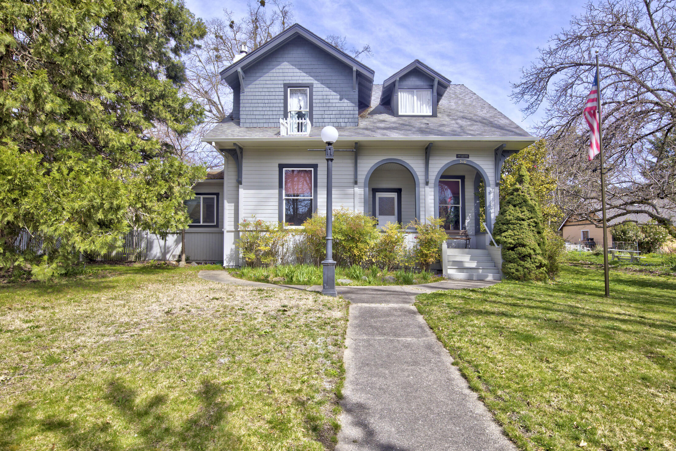 Charming early 1900s Victorian Cottage, nestled in the heart of Northwest Grants Pass. This home features beautiful craftsmanship that you will not find in modern homes. It has been well maintained throughout the years. It has 4 bedrooms, 2 bathrooms and is just over 2000 square feet. It has a detached two car garage and a car port. The property is a larger property at one-third of an acre. This is a must see and will make a great home for its next owner!