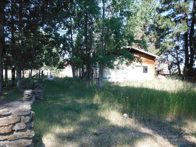 Nice 0.34 acre lot that could be dividable or build your home in the pine trees. Alley access at the rear of the property & Maple Street access also. Selling property as vacant land. No value in the structure.