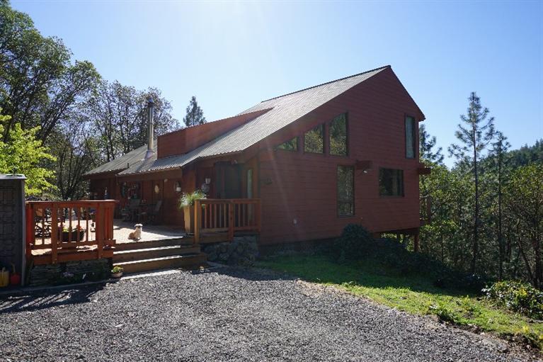 This beautiful home features mountain views, privacy, just down the road from Jacksonville Forrest Park, all the activities the area has to offer, and still just a couple minutes from Downtown Jacksonville. This is a great 3 story, 4 bedroom, 2 bath home with an updated kitchen. 3 bedrooms downstairs, 1 bedroom on the main floor and a loft/office area on the third floor. There is a great deck for BBQ-ing or just enjoying the amazing views. The home sits on 3.9, fenced acres. Plenty of room for RV Parking. There is a 3 car garage/shop and horse stalls. Current owner has ran horses on the property. This home is a MUST SEE!!!!