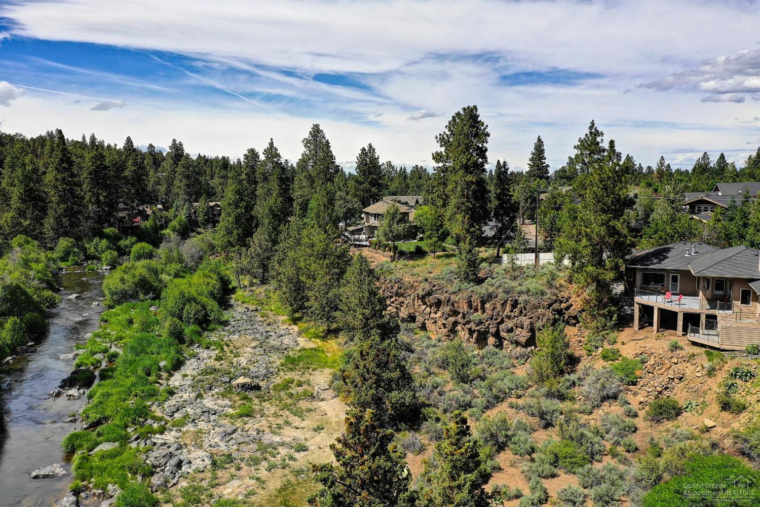 Casually elegant one level home on 1/2 acre w/Deschutes river views & a coveted short-term vacation rental permit. Easy access to the river, trails, Sawyer Park. Gated entry. 3 bedrooms, 2.5 baths & small office. High end finishes, gorgeous hardwood & stone floors & custom built-ins. Great room w/wood burning fireplace, dining area & gourmet kitchen open to living & dining with stainless steel appliances. The Master suite has stunning river views, deck access, a huge walk-in closet & bath w/marble floors & large soaking tub. Enjoy the best of indoor/outdoor living on the large deck for entertaining or relax in the hot tub with the views & sound of the river. Large utility room with tons of cabinetry & heated finished bonus room off lower deck. Generous parking & turn around area, covered breezeway & over-sized garage. This is a special opportunity to own a home that offers not just the views but easy access to the river as well, perfect for your private getaway or for use as a VRBO.