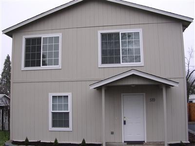 Two family set-up. Two houses on one tax lot. Built in 2004. The first unit is 1400 sq. ft., 2 story, 3 bedroom, 2 bath with laundry hook-ups & appliances. The back unit is accessed through the alley. It is a one story, 700 sq. ft., 2 bedroom, 1 bath with appliances & laundry hook-ups. Both units feature new vinyl flooring & carpet on main floor & ample parking. Vacant at this time - previous rents were $900 for the 1st unit and $750 for the 2nd unit.