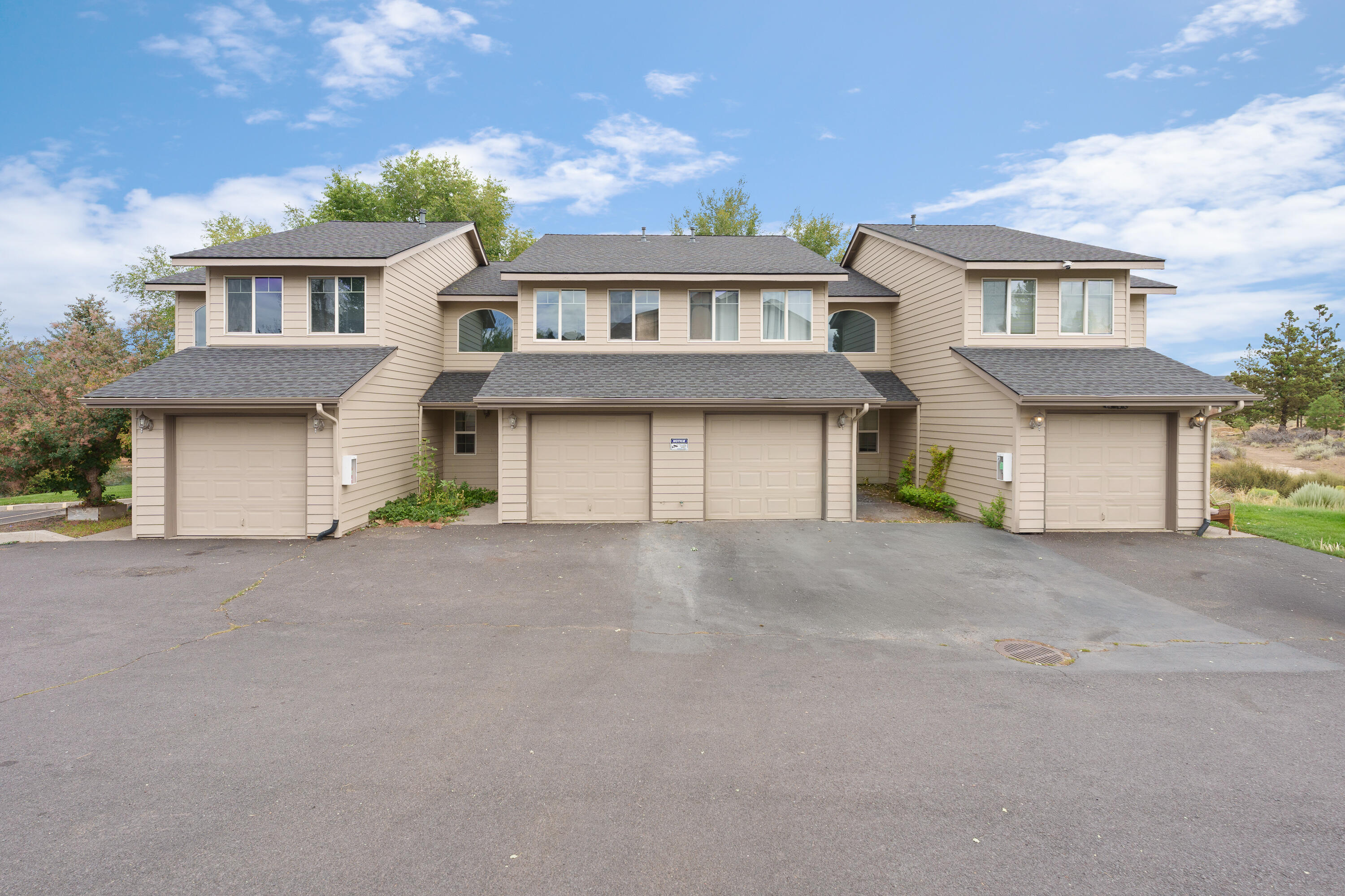 Situated on a quiet, desirable street on Bend's NE side, this mostly leased 4-plex offers great rental income with a newly painted exterior and a new roof. Three units have been upgraded with new carpet, new vinyl plank flooring and new interior paint. Each spacious unit features 3 beds, 2 baths, and 1,060 sq. ft. of living space spread across two levels. Enjoy private rear decks, cozy gas fireplaces, and convenient in-unit washer and dryer hookups. The lower level includes functional kitchens, dining areas, a cozy living room and a full bathroom. Upstairs, you'll find three bedrooms and a full bathroom. The property also includes attached garages and a future park right next door. The property is close to St. Charles, Pilot Butte and numerous additional amenities.