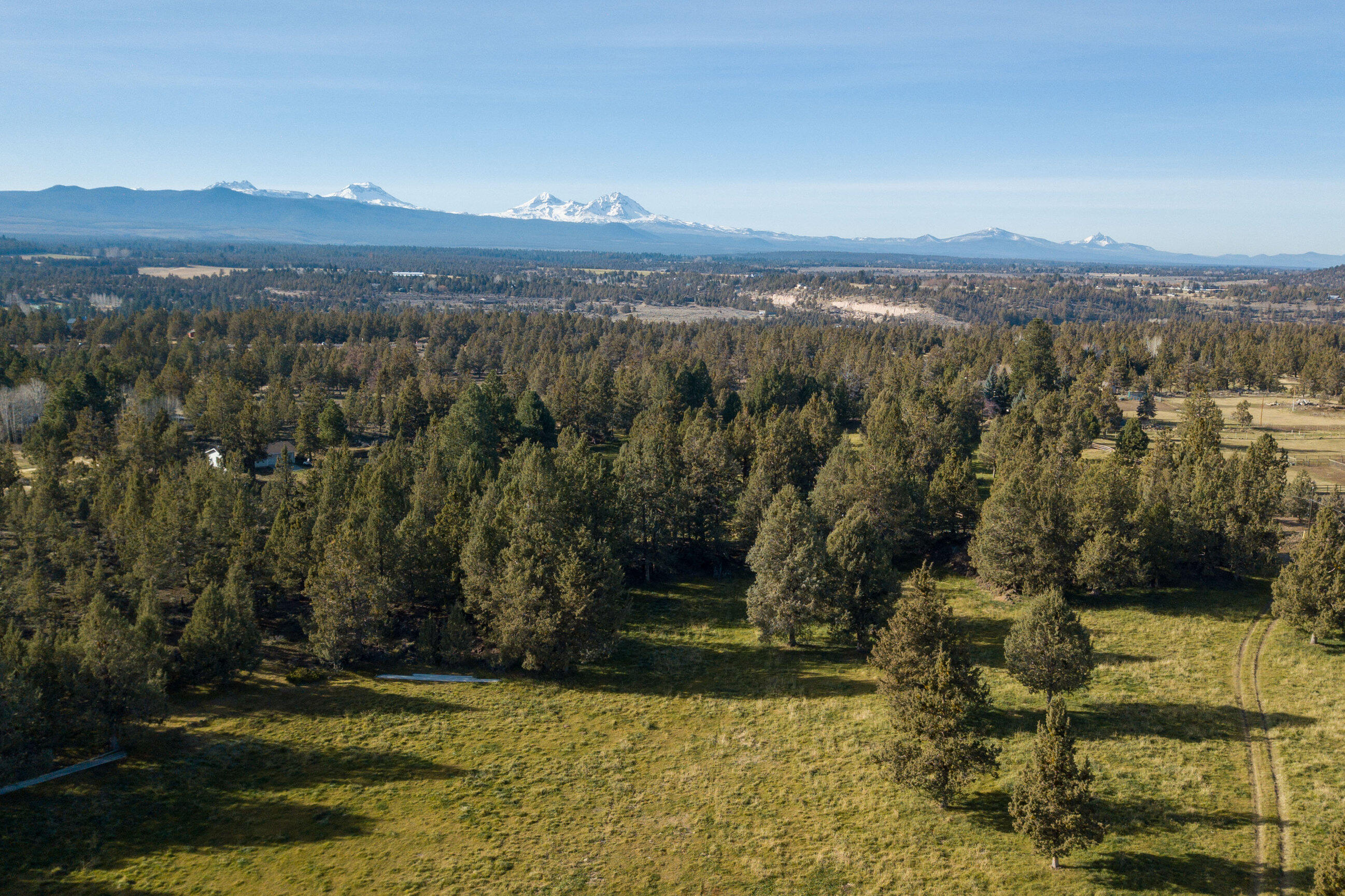 Picturesque-stunning-irrigated-view land,  prime close-in location!  You've been waiting for that special property to build on, or hold, and this one has it all.  Close to town this 36+ acres is fenced, gated, irrigated, has paved road frontage.  Lovely NW Bend acreage is situated near the edge of town, but convenient to Redmond, Tumalo, and Sisters.  Several nice out-buildings already on-site, mature trees, rock outcroppings, amazing views, this offers many possible sites to create your own private hidden dream home.  Scenic ponds on the property for irrigation water; great for grazing, pasture, or your choice.  May be possible to split this property ( talk to county planning ) if more than one home is desired. Currently zoned MUA-10 acre minimum.   Power is already in place, property is completely fenced & gated.  Location, location, location just a stone's throw from everything.  Call now to view this special land.