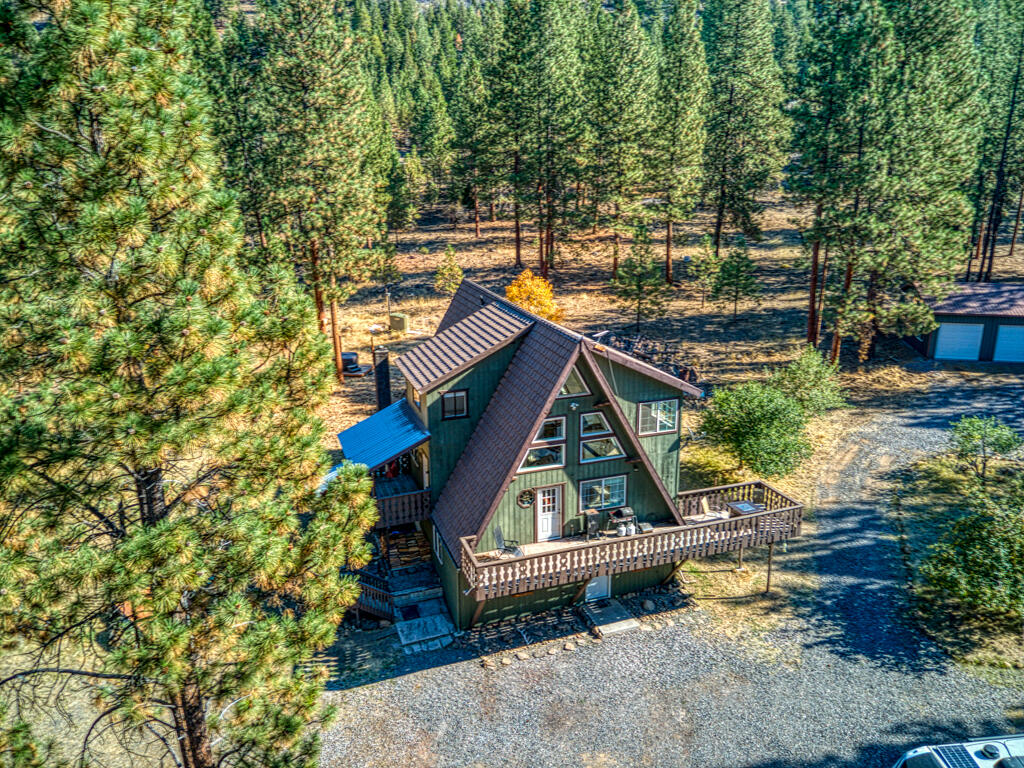 Country living close to town! This rare gem sits on 11.35 acres, 5 acres is fully fenced with gated access. Enjoy the views and relax on the covered porch. The main level features the kitchen, family room, & dining area with an abundance of natural light. The main level also features a spacious primary bedroom with a newly remodeled ensuite bathroom. Upstairs includes a loft area, large bedroom with a full bathroom. The lower level has another family room, bedroom, full bathroom and a bonus room that could be a 4th bedroom. Outside features a recently built 25'x35' shop with RV hookups and expansive views of the valley. This home has so much potential to make it your own oasis. There is even a chicken coop, a fenced area for animals & multiple fruit trees!  New well pump and all new well components in 2020. East side of property backs up to BLM land. If you're looking for privacy or to start a homestead this property is for you!