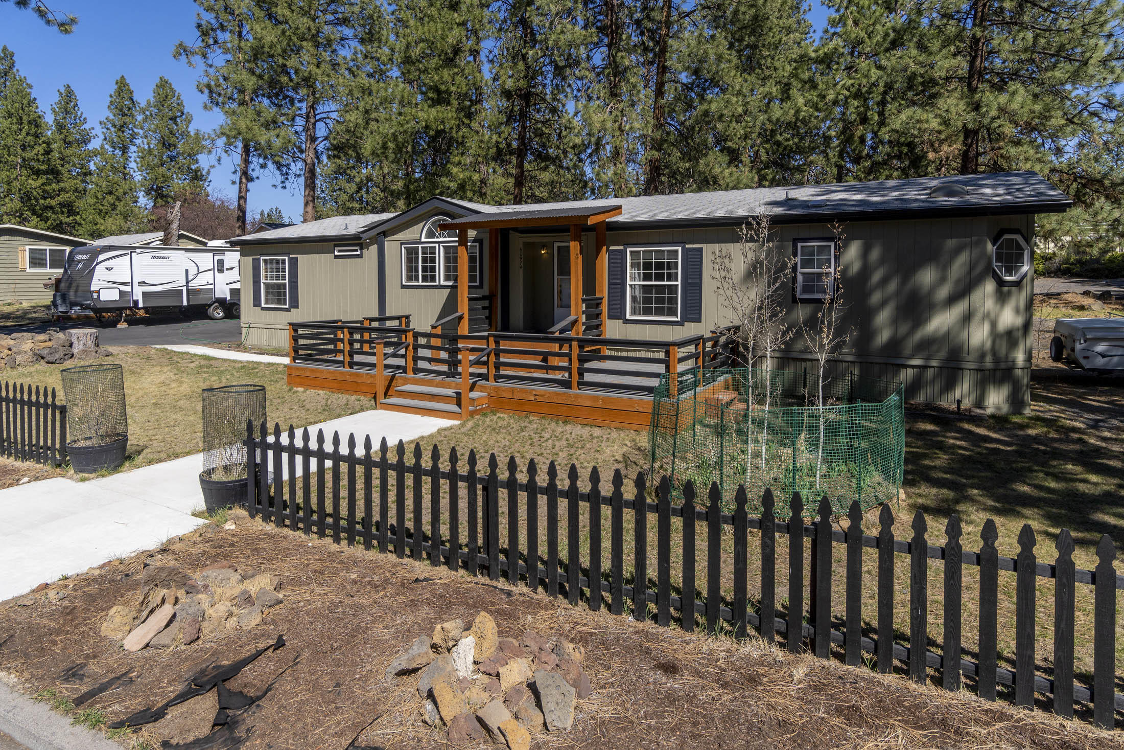 Nestled in the pines of Romaine Village situated on a corner lot is this wonderful home hooked to city sewer & Avion Water.  Centrally located to the Riverwalk Trail along the Deschutes River, Amphitheater, Old Mill District & an abundance of restaurants to choose from. 3 bd plus office, 2 ba, dining rm, open great rm & spacious kitchen w/ cabinets galore.  Master Suite has large walk-in closet, soaking tub, separate shower & dual vanities.  Guest bedrooms are on opposite side of home allowing complete privacy.  Don't miss the separate Art Studio in back & 3 Garden shed.  Enjoy outdoor entertaining either on the front deck or backyard on your massive deck with extensive use of pavers.  The huge yard is completely fenced w/ plenty of room to park an RV.    2 car garage is detached w/ plenty of space for all your toys.  1500 sf paved driveway, compacted gravel for RV/Boat parking.  Option to enjoy the amenities of Romaine Village w/ pool, playground & clubhouse, you will have to join.