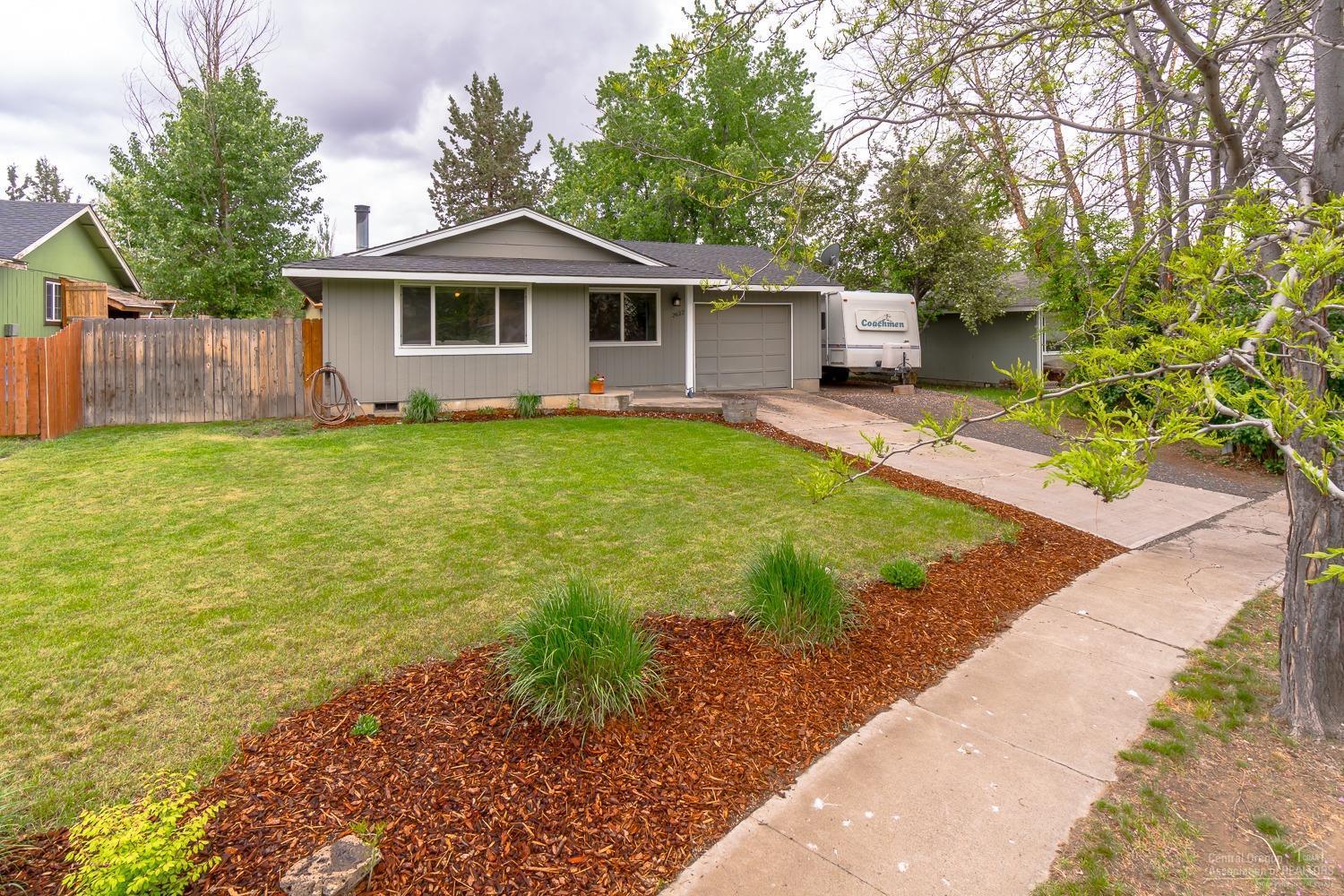 Charming single level home recently updated on an equally charming tree lined lot and street. This home with new flooring & paint has a fresh and cozy feel the moment you walk in. The kitchen with a center island was recently updated with new hard surface counters, tile back splash and white painted cabinets. The kitchen also has a spacious dining area as well. The bathroom is roomy and also recently updated with a new vanity, quartz counters and all new hardware. The real bonus is the versatility of the outdoor living space. A side deck and yard is perfect for entertaining or enjoying an evening around the in ground fire pit located just beyond the deck. Or let the kids and/or dogs play in the private landscaped fenced backyard. There is even room for toys and RV parking as the garage has a pull thru all the way to the back yard! Situated on a larger .15 acre lot on a cul de sac street this adorable home gives you privacy and a true neighborhood feel.