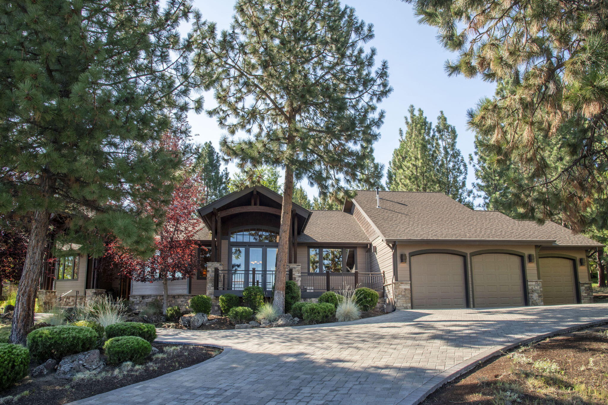 Stunning Custom Built Single-Level on Awbrey Butte with Mt. Jefferson Views! This exquisite Northwest style home is perched on nearly a ½-acre lot, offers a perfect blend of elegance, comfort, and design on Bend's coveted Awbrey Butte. The great room features vaulted beam ceilings, a gas fireplace with stone surround and hearth, built-in buffet and bar area, and French doors opening to the deck, all framing the sweeping Mt. Jefferson views and perfect for enjoying the gorgeous Bend sunsets. The gourmet kitchen is a chef's dream with black stainless appliances, a Décor range, BlueStar double ovens, granite counters, a walk-in pantry, and a large eating bar. The luxurious primary suite boasts dual closets, radiant-heated bathroom floors, a large walk-in shower, double vanity, and a private deck to enjoy the views. Additional highlights include an oversized 3-car garage with workshop & storage, a whole-house generator & a heated paver driveway. Meticulously maintained and move in ready!