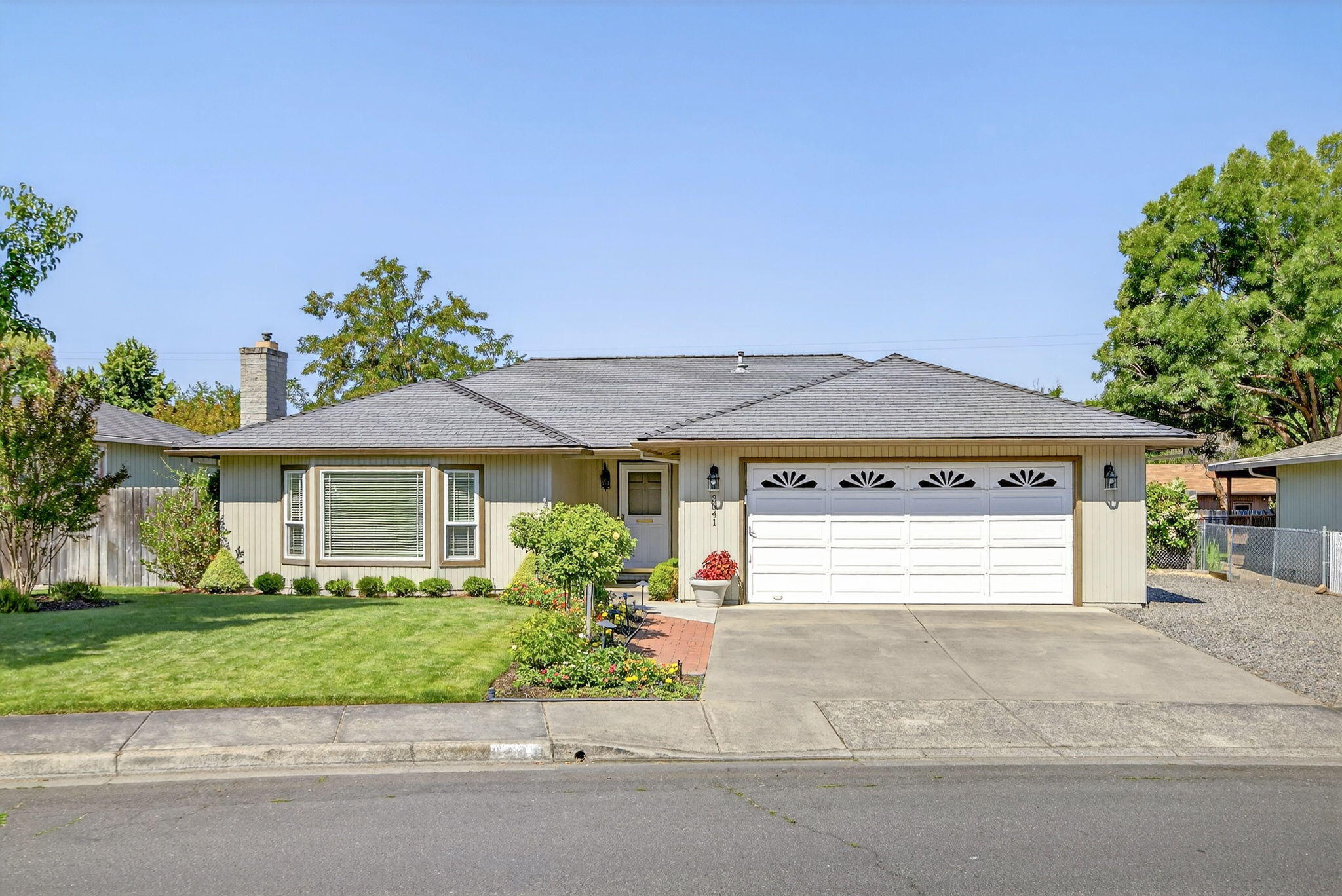 Buyers will adore this charming, single-level 3-bed, 2-bath home in NE Medford, complete with RV parking. The properties exquisite landscaping in both the front and back, create a beautiful outdoor area perfect for relaxing and unwinding. Inside, you'll find a welcoming space featuring a gas fireplace, hardwood floors in the dining area and hallways, quartz countertops in both the kitchen and bathrooms, and an indoor utility room. The primary suite offers a walk-in closet and walk-in shower. Step out from the dining room onto a paved patio and enter your own private, and fully fenced backyard. This outdoor oasis is ready for enjoyment with a charming gazebo, fountain, and two storage sheds. The two-car garage provides plenty of space with attic access for storage, a workbench, and shelves throughout.