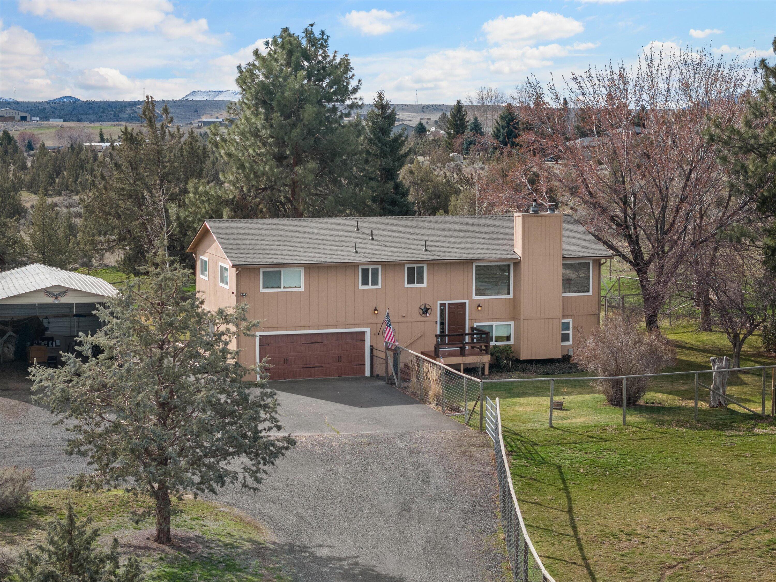 Beautifully remodeled split-level w/ mountain views & space for animals. On 2.16 acres w/ horse facilities including a loafing shed & fenced areas w/ horse & goat barns. Beautiful laminate flooring throughout main level. Living room w/ stack stone accent wall, 3 picture windows & cozy stone fireplace w/ pellet stove insert.. Kitchen w/ granite countertops, attractive cabinetry, ss appliances & sliders to large upper deck. Primary bedroom w/ private bathroom. 2 additional bedrooms & full bathroom complete main level. Backyard w/ shade trees, cross fencing, barns for animals, RV parking w/ hookups, tool shed, sprinkler system & security lights. Conveniently close to amenities, including restaurants, Madras airport & easy access to highways 26 & 97. Recreational opportunities w/ the Cove Palisades Resort a 20-minute drive.