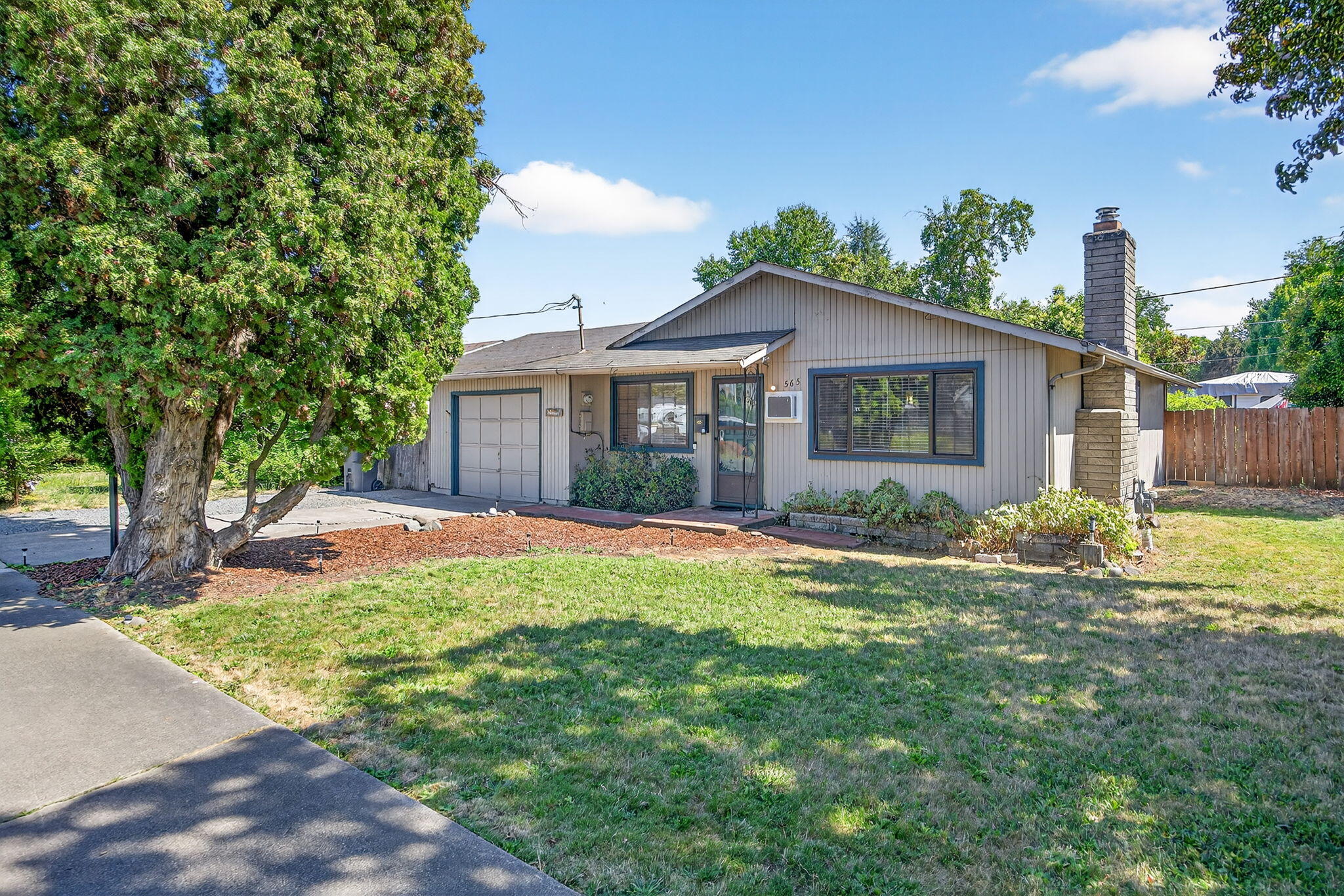 Lovely 3 bedroom home with a private back yard, conveniently located in South Medford. This gem has a galley kitchen with pull-out storage, a new range, dishwasher and refrigerator. The dining area is open to the living room where there is a/c for the summer and a gas fireplace to warm yourself in the winter. The three bedrooms have hardwood flooring and nice sized closets. The bright and fresh bathroom has a tile bathtub/shower and a new vanity. Updated vinyl windows help with energy efficiency. There is a laundry room off the kitchen that leads to the backyard. Outback enjoy your shaded yard with a patio, grass area and mature landscaping. The single car garage with work benches is accessible from the back patio. There is a covered storage area that can house your garbage cans and more. To top it off there is a stick built storage room asking to be utilized. Additional parking adjacent to the garage has been freshly rocked in. This home is waiting to make it yours!
