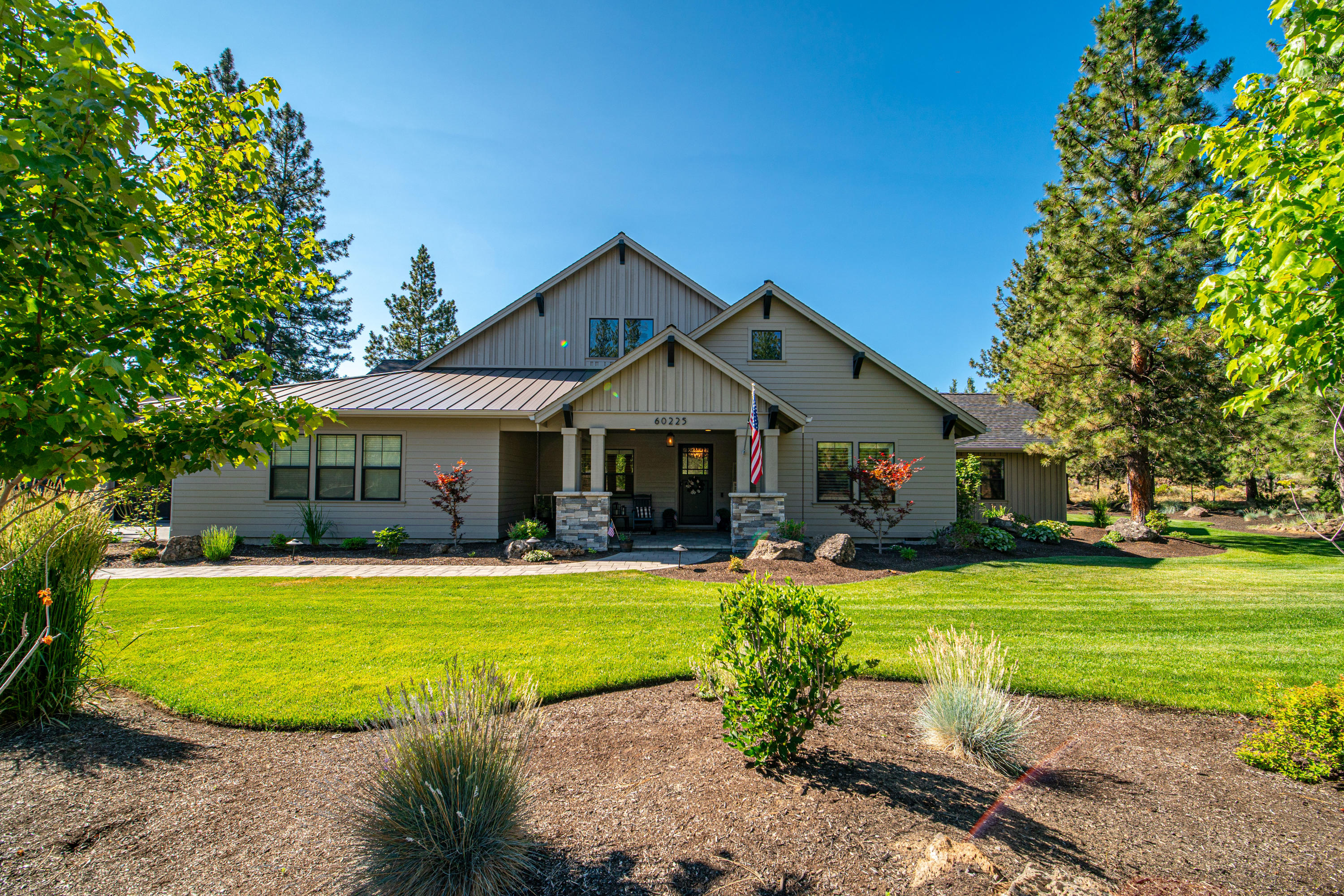 Amazing ''Modern Farmhouse'' on the Golf Course in Sunset View Estates! This custom, one-of-a-kind home is the epitome of an entertainer's dream. The vaulted great room's floor-to-ceiling windows overlooking the backyard and 9th fairway draws you in, while the kitchen, with its 10' center island, provides a place for all to gather and invites you to stay awhile. You will appreciate all the thoughtful designer features of this extraordinary home: a gracious primary suite, 2 jr. suites + a 4th bedroom & bath; a chef's kitchen with Thermador appliances; cozy living room fireplace, Carlisle wide plank Oak flooring; marble, quartz, soapstone & tile finishes; Montana Ghost Wood wrapped beams, numerous built-ins, shiplap & wainscoting accents; a bonus room ready for movie night or the big game with wet bar & surround sound theatre system; dedicated office; (2) 2+car garages with custom storage. Outside, enjoy the covered patio and built-in BBQ, then stargaze around the fire pit seating area.