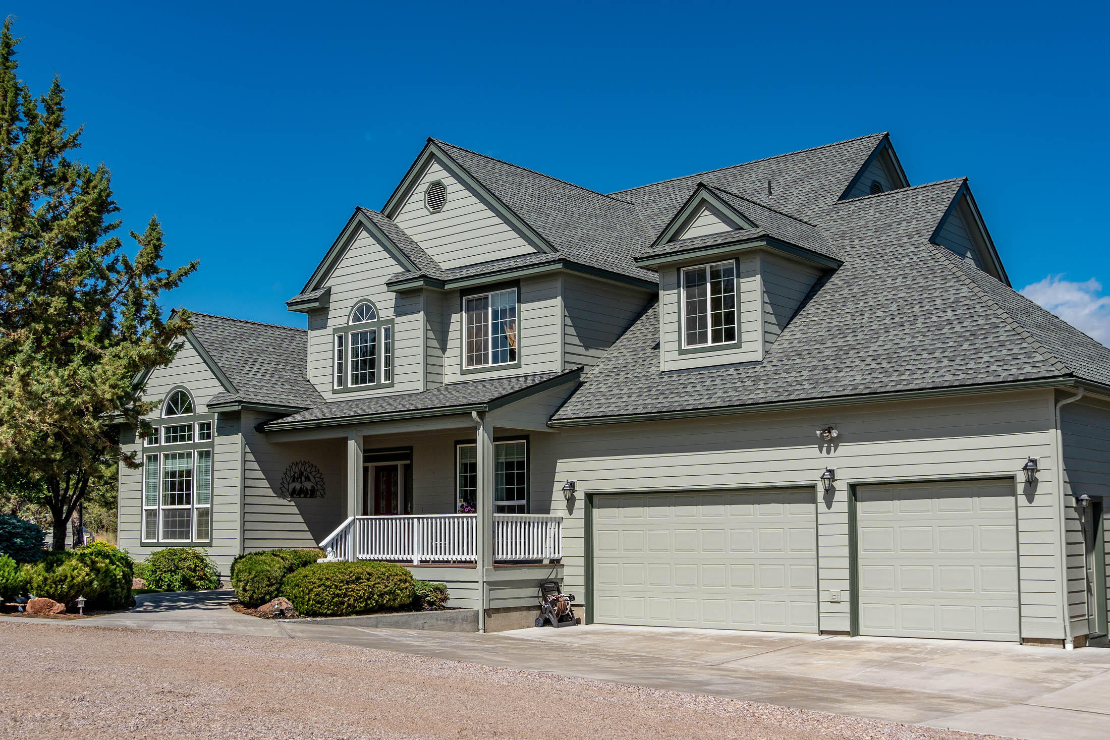 Look! 5-acre legacy property w/ stunning Cascade Mtn. & valley views w/ 3,505 SF of living, 4 bed, & 3.5 baths. Award-winning architecture coupled w/ immaculate care, this custom home offers solid hardwood floors. Large windows w/ vaulted rooms captures the mountains. This beauty boasts 2 primary suites located on the main level near office & 2 story entry. 5-piece primary bathroom highlights a jetted tub coupled w/ tile shower & floors. Large kitchen w/ island & custom cabinetry, granite tile counters w/ butler's pantry (wine fridge) & desk. Well maintained HVAC, heat pump w/ propane heat back up (+ 3 fireplace inserts: FR, GR & Primary). Hold all your toys w/ attached 3-car garage and separate 1360 SF shop w/ double RV doors is ready for all your hobbies (loft, bathroom, & heated hobby room). Additionally do not forget the expansive, deer-resistant fenced Garden w/ equipment/mower shed nearby.  This resort-like dream is turn-key ready; schedule your own personal tour today!