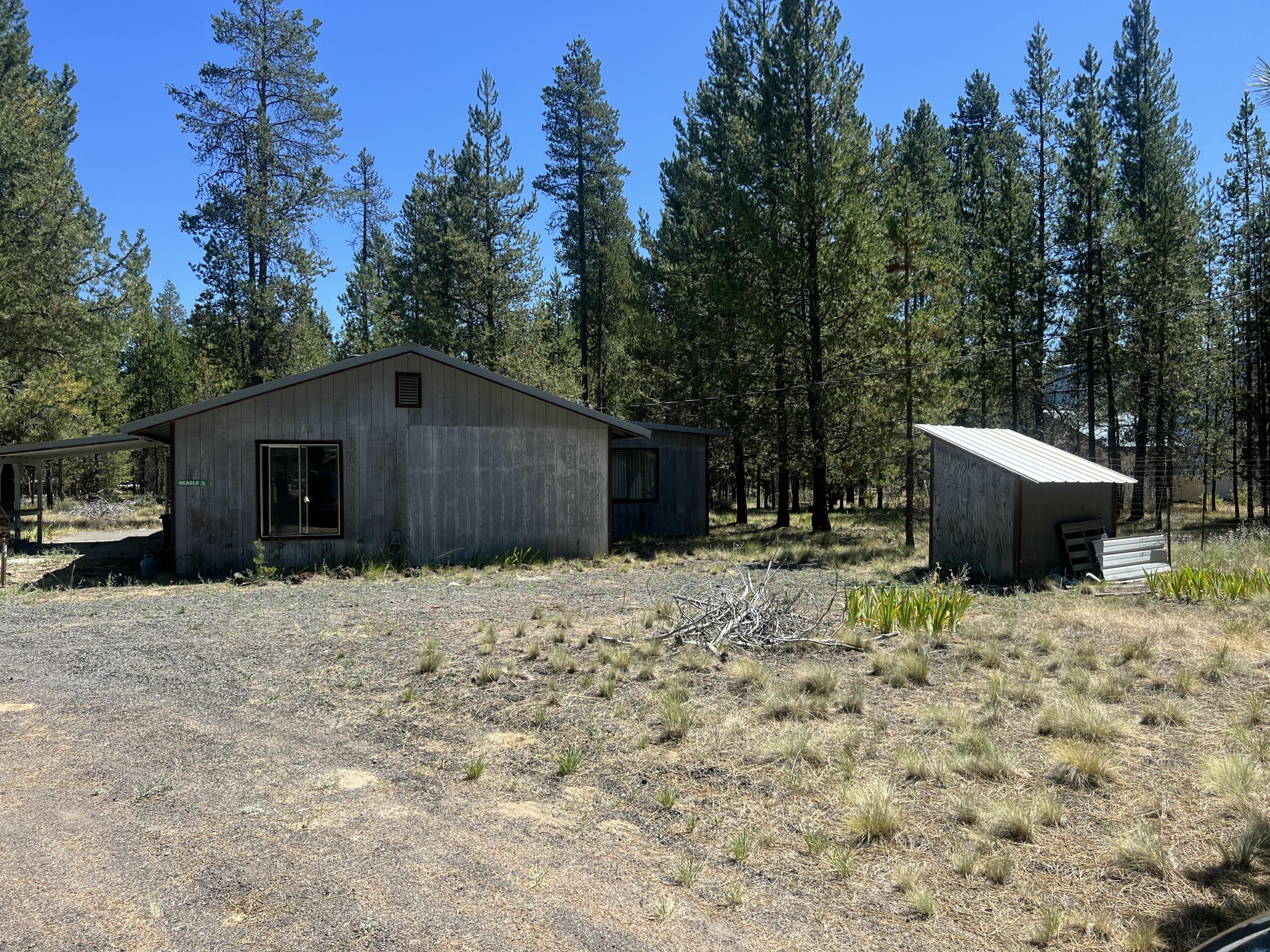 Discover the potential of this 1.44-acre property in the heart of La Pine! This 1-bedroom, 1-bath, 672 sq ft home is ready for your vision and a little TLC to make it shine again. Surrounded by mature trees and fresh mountain air, you'll enjoy the peaceful setting being close to all that Central Oregon has to offer. Spend your days exploring nearby lakes such as Wickiup Reservoir, Crane Prairie, and Cultus Lake, or head to the Deschutes River for fishing, kayaking, and paddleboarding. With endless trails for hiking, biking, snowmobiling, and ATV adventures, this is an outdoor lover's paradise. Whether you're looking for cozy getaway, an investment project, or a future dream home site, this property offers the perfect opportunity to create something truly special.