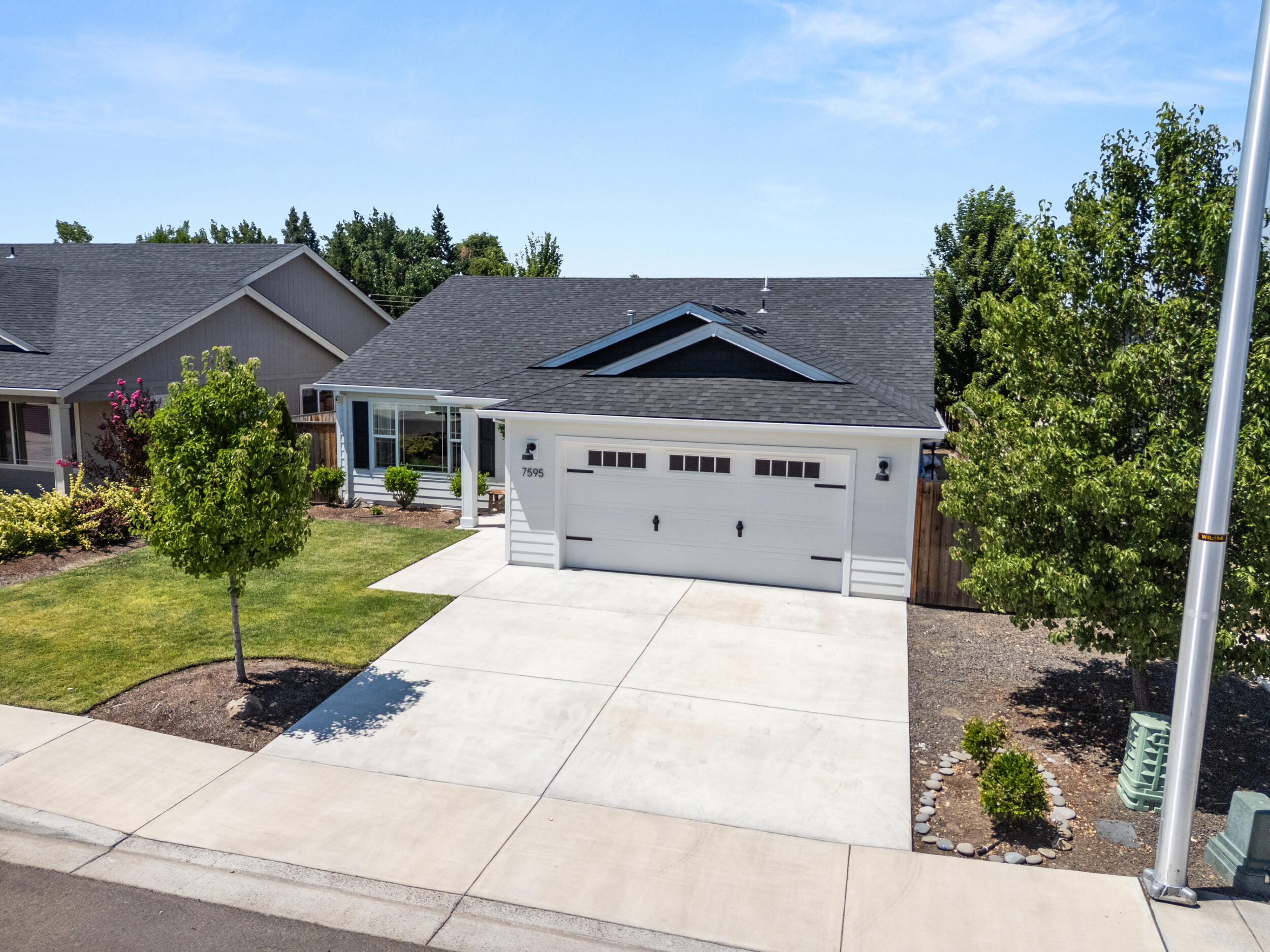 This is a 3-bedroom, 2-bath, one-owner home. The floorplan is open and welcoming with a vaulted great room and offers 1,623 square feet of stylish living space. Wilson Way is a dead-end street consisting of 10 newer homes on the east end of Antelope Road. The kitchen is a standout, showcasing granite countertops, subway tile backsplash, walk-in pantry, and ample cabinetry, perfect for both everyday use and entertaining. The coffered-ceiling primary suite feels like a relaxing retreat with a walk-in closet, dual vanities and extra storage. The landscaping has had some time to mature, with both front and back lawn space. The covered back patio provides the ideal space for outdoor enjoyment. Finished 2 car garage and the home's like-new condition reflects true pride of ownership throughout.