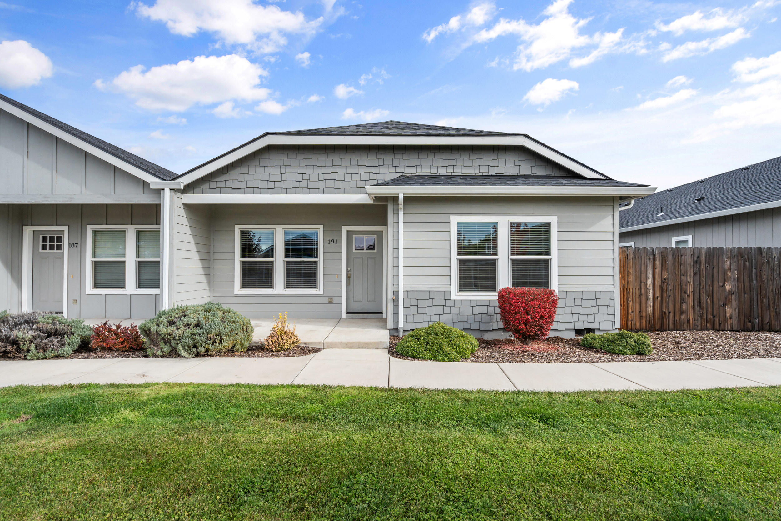 Beautifully built in 2019, this modern Medford home offers over 1,400 sq.ft. of stylish living space, featuring 3 bedrooms and 2 bathrooms. The open floor plan with vaulted ceilings creates an inviting atmosphere, perfect for entertaining. The kitchen features a large island, granite countertops, stainless steel appliances, and a walk-in pantry, making it ideal for any home chef. The spacious primary suite features a walk-in closet and a private en-suite bathroom with a sleek walk-in shower. Gorgeous finishes, laminate flooring, and an abundance of natural light enhance the home's modern charm. Complete with a 2-car garage and low maintenance yard, this move in ready gem combines comfort, functionality, and timeless design for its next proud owner.