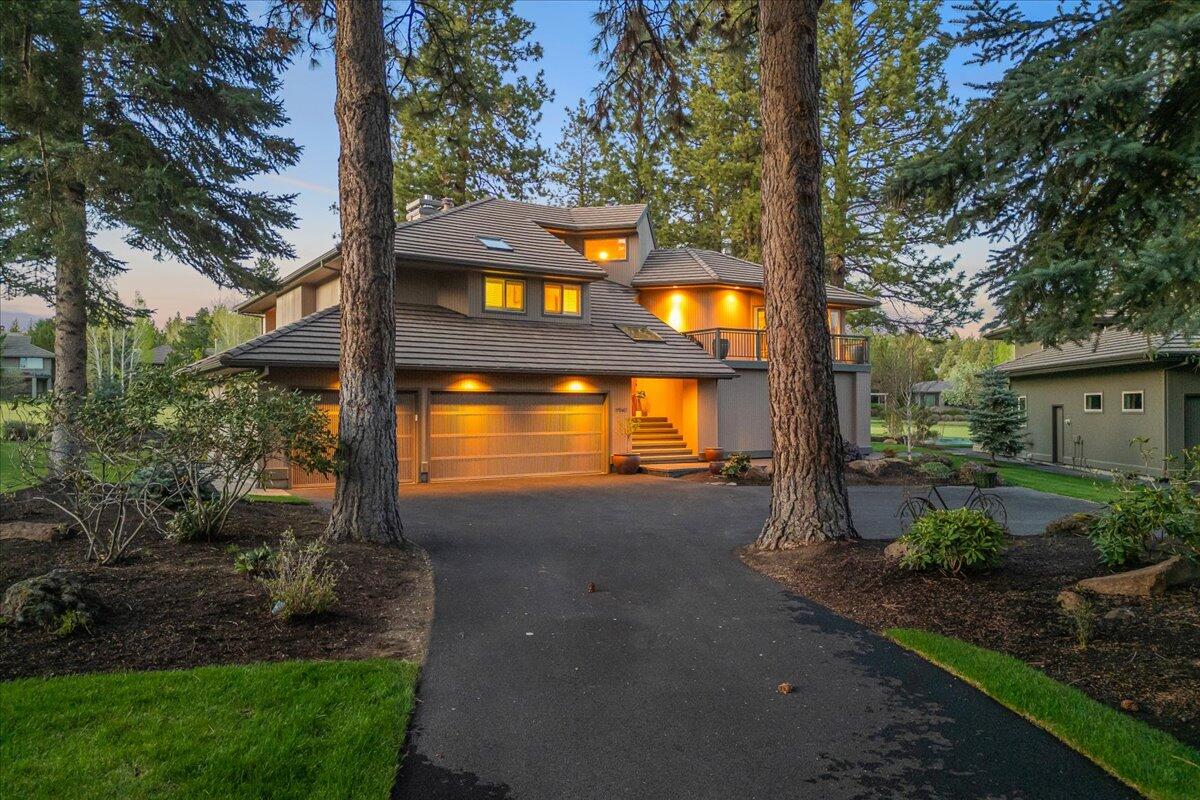 Situated along the 17th fairway of Broken Top, this sun-filled home captures sweeping golf course views and showcases the craftsmanship and refined finishes that define Sun Forest Construction. Step inside to a warm, inviting great room where a floor-to-ceiling stone fireplace, custom built-ins, & soaring fir ceilings create the perfect gathering space. The kitchen is thoughtfully designed for both everyday living and entertaining. Mornings feel especially peaceful from the bright breakfast nook or the sun-drenched front deck, ideal for that first cup of coffee. The main-level primary suite opens directly onto a wraparound deck with front-row seats to the fairway. Downstairs, the walk-out level is built for hosting or relaxing, with a large family room, built-in library shelving, wine closet & three guest bedrooms— opening onto a generous covered patio overlooking the course. An oversized three-car garage ensure plenty of space for bikes, skis, golf carts, & everything in between.