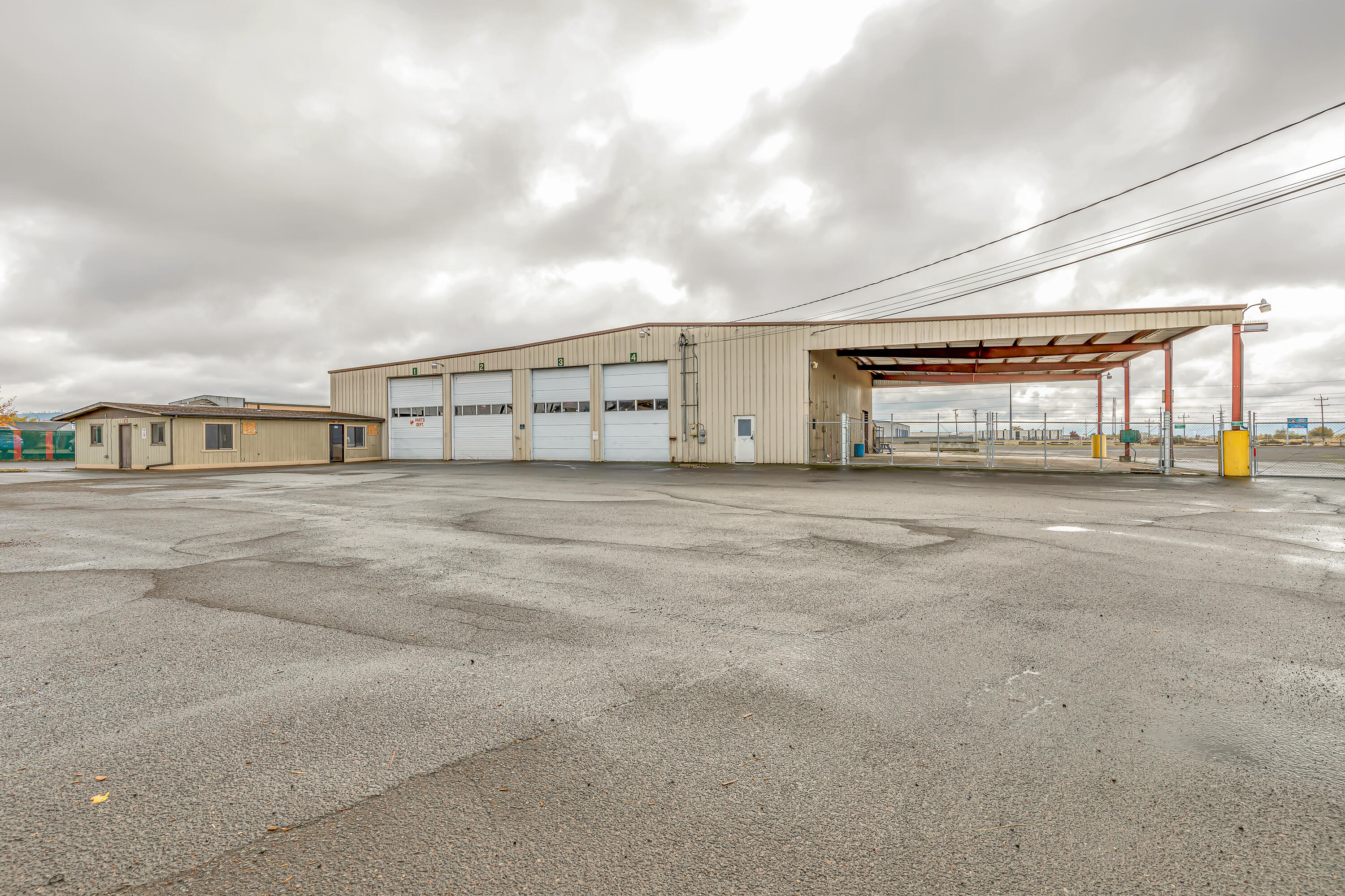 Amazing industrial opportunity! Located in the federal opportunity zone and with light industrial (LI) zoning, this property offers a huge 10,602 sqft building with 8 large roll up doors (4 in the front and 4 in the back) and a huge covered carport with an abundance of space for large vehicle and machine storage! The building also has a small office space attached in front and additional rooms/offices in the warehouse. This lot is centrally located and allows for easy access to Hwy 140, Hwy 62, I-5 and the Express way. This desirable lot also includes 4 additional surrounding lots to accommodate parking and storage for large vehicles, boats, trailers, machinery and more! A great opportunity in an ideal location for owners and customers alike, you won't want to miss it. Call to schedule a showing today! For more details, please contact listing agent.