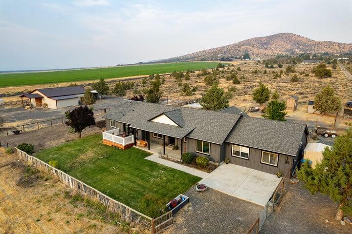 Enjoy Cascade Mountain Views and the peaceful surroundings of this 5.44-acre property located in Powell Butte! Beautiful single level home with 4 bedrooms & 2 baths. Garage was previously converted to bonus room, office/flex space & mud room. Potential for a separate living space. Lots of light, vaulted ceilings, formal dining area and an open floor plan. Breakfast bar, granite countertops in the kitchen with/stainless steel appliances. 324 square foot gorgeous bathroom remodel/add-on to the main bedroom. with custom cabinetry and a huge walk-in closet! You just have to see it! Main bedroom is separate from the other bedrooms. Property is fenced & cross fenced. 36x48 barn w/ electric & water and a couple of 12x12 stalls. Shop area in barn along with an office/flex room. Multiple pastures, lean-to,12x12 slab enclosed storage area. Plenty of parking! Landscaped fenced yard includes in ground sprinklers front & back.