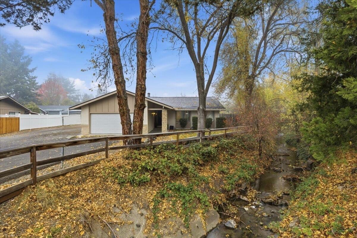 Currently operating as a successful Airbnb, this beautifully maintained property offers an exceptional investment opportunity (with furnishings available for purchase) or the ideal place to call home. The beautifully updated kitchen showcases sleek quartz countertops, newer stainless-steel appliances, a spacious breakfast bar, and modern cabinetry, creating the perfect space for cooking and entertaining. Ideally situated directly across from the Rogue Valley Medical Center and within the sought-after Hoover, Hedrick, and SMHS school district, the location provides unbeatable convenience and strong long-term value. A picturesque stream runs alongside the home, adding a serene, natural ambiance that enhances the property's unique charm. Additional highlights include a cozy wood-burning fireplace, ample parking, and a welcoming covered front entry. With its inviting atmosphere, thoughtful upgrades, and prime location, this home stands out in today's market!