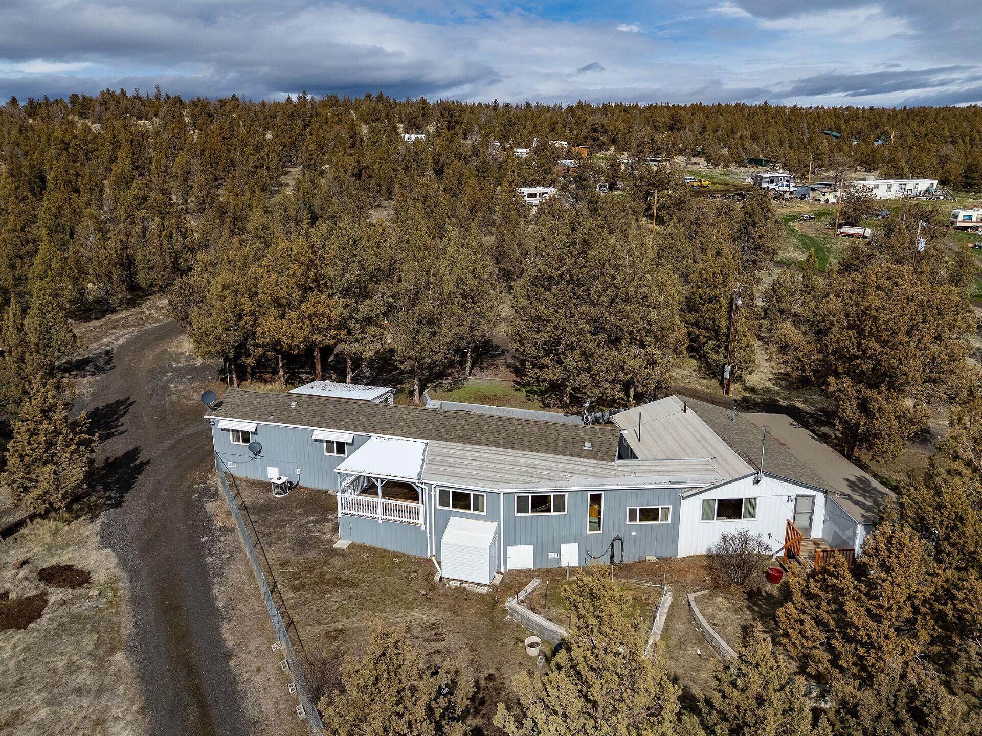 Country living on Central Oregon's High Desert on 10.70 acres with huge 1800 Sq Ft insulated shop! Bring your horses or animals to this private, fenced and gated property. Multi-generational living option in this 2338 Sq Ft Good Sense home built to Alaskan Standards in 1993. Large frame-built addition with living and sleeping area plus sunroom with beautiful knotty pine accents. Private well, green house, garden area and several covered parking structures & RV areas. Centrally located between Prineville Reservoir and City of Prineville, offering fishing, boating, hiking or hunting on the area's public lands. Perfectly situated to enjoy the natural beauty of Central Oregon's Cascade Mountains and their stunning sunsets!