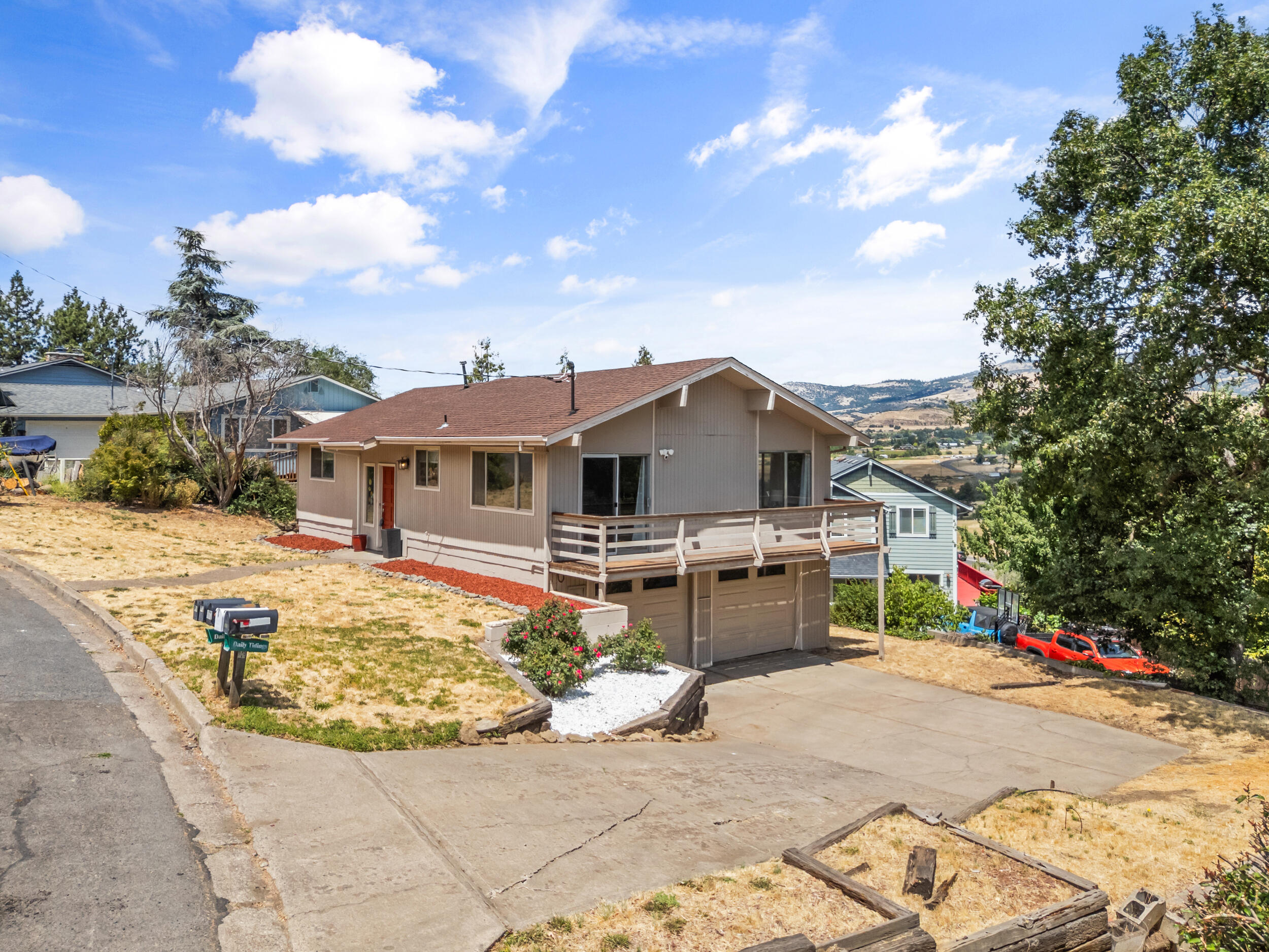 Bask in the beauty of Ashland living with this stunning 3 bedroom/2 bath home, offering over 1,700 sq.ft. of comfortable, elegant space and breathtaking views of the Cascade Mountains and surrounding valley. Expansive windows flood the home with natural light, highlighting the open layout and updated finishes throughout. The spacious main level features a beautifully renovated kitchen, two full bathrooms - including a private primary suite - and ample closet space for storage. Downstairs, discover a bonus room with its own entrance, perfect for guest suite, home office, or creative studio. Recent upgrades include a new roof and modernized heating and air system for energy-efficient comfort year-round. Enjoy peaceful mornings on the deck, take in the sweeping views, and experience the tranquility this home provides. Nestled in a desirable Ashland location with an attached 2-car garage, this home blends luxury, warmth, and versatility for the perfect lifestyle retreat.